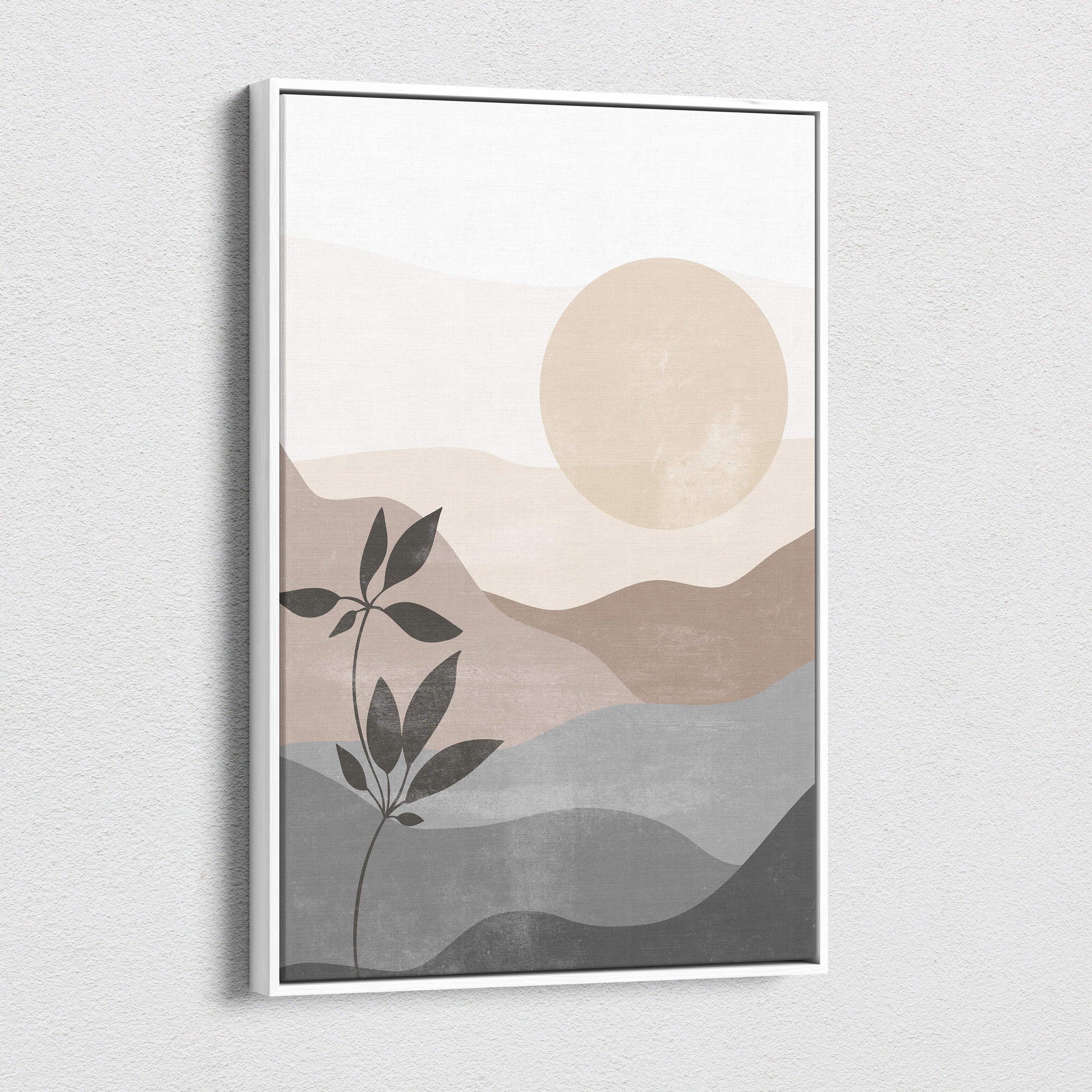 Minimalist framed canvas wall art featuring abstract layered mountains in beige taupe gray with a peach sun and green plant silhouette