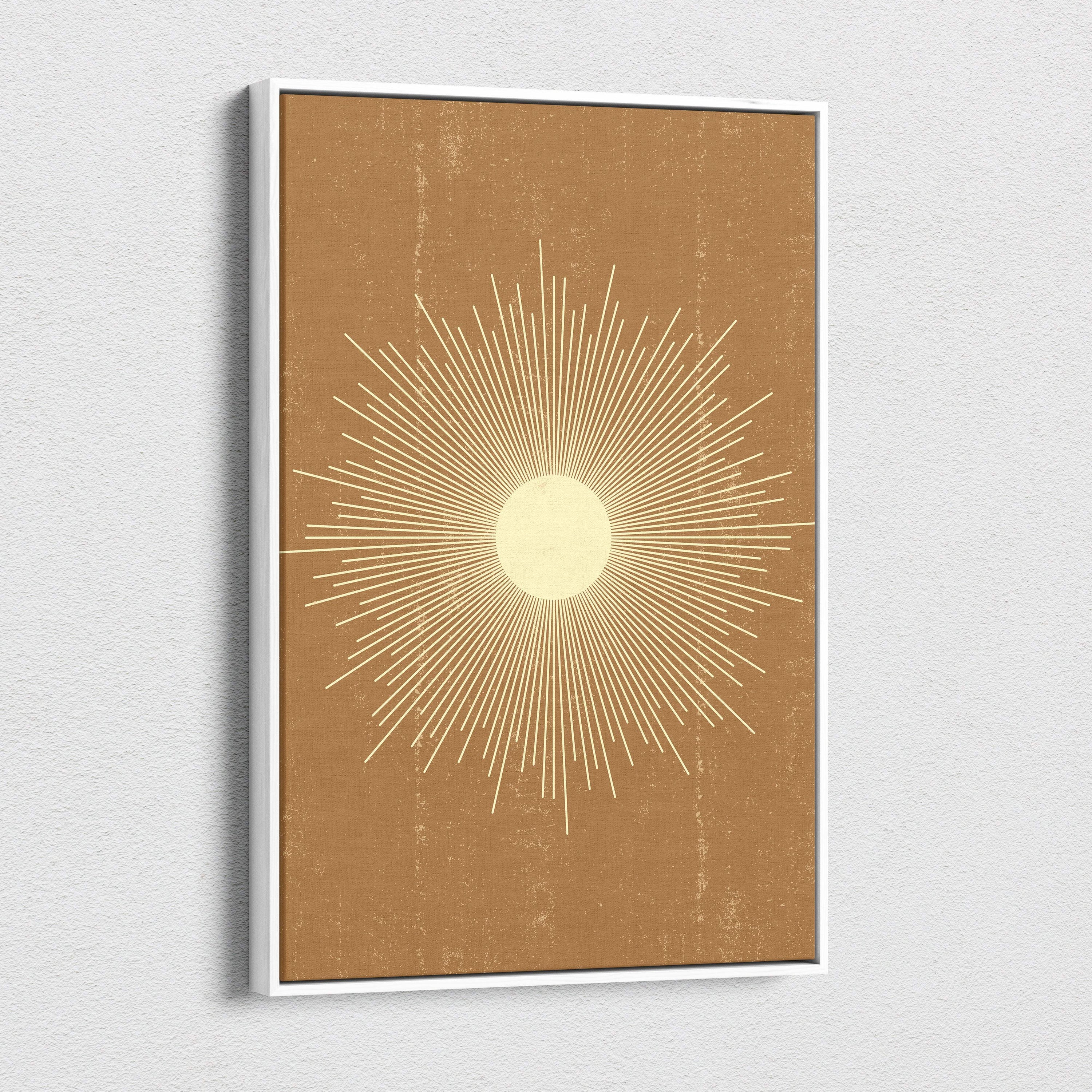 Minimalist framed boho sunburst canvas wall art with cream and gold tones on textured terracotta background for living room