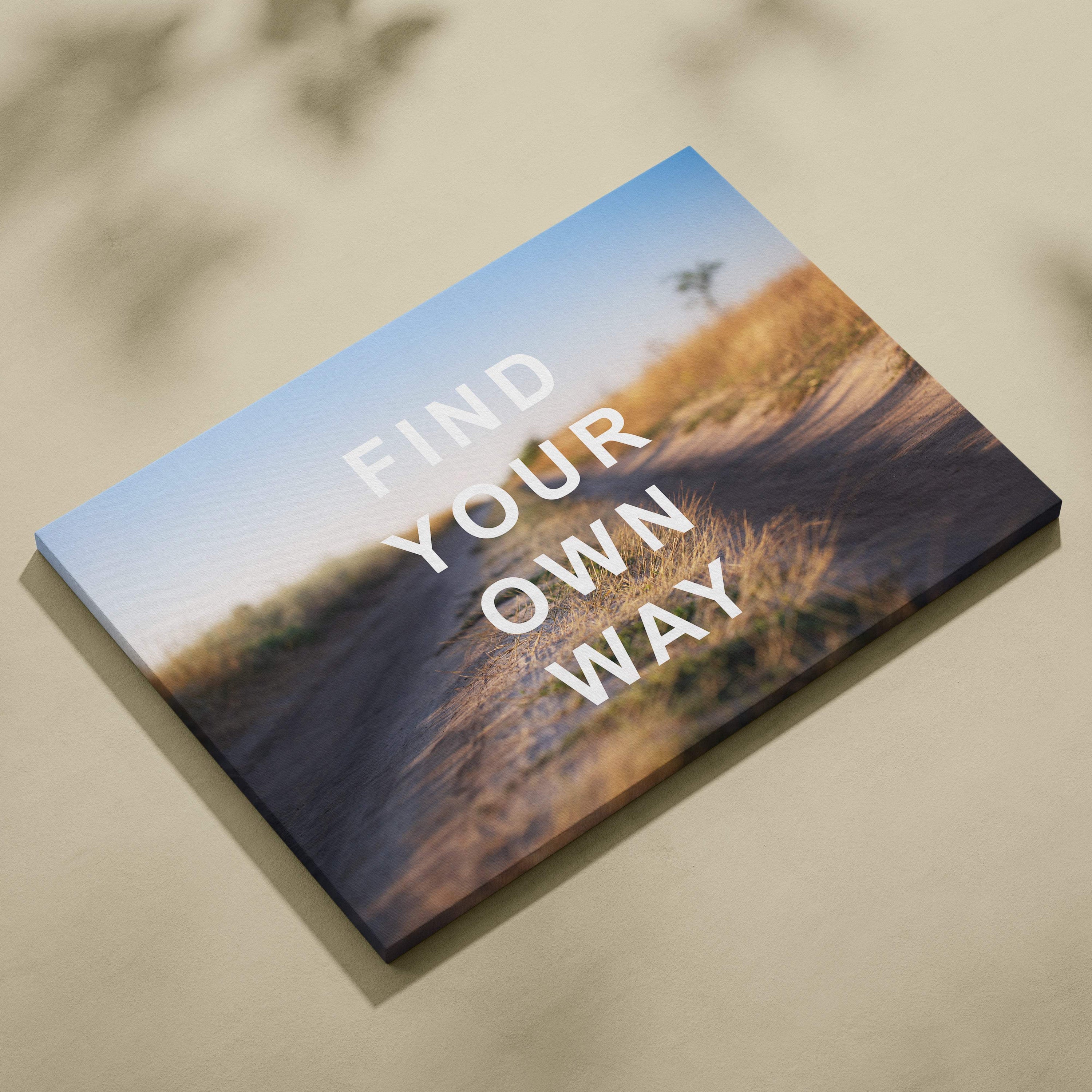 Motivational find your own way canvas wall art of a scenic dirt road through golden grass under blue sky for office or bedroom