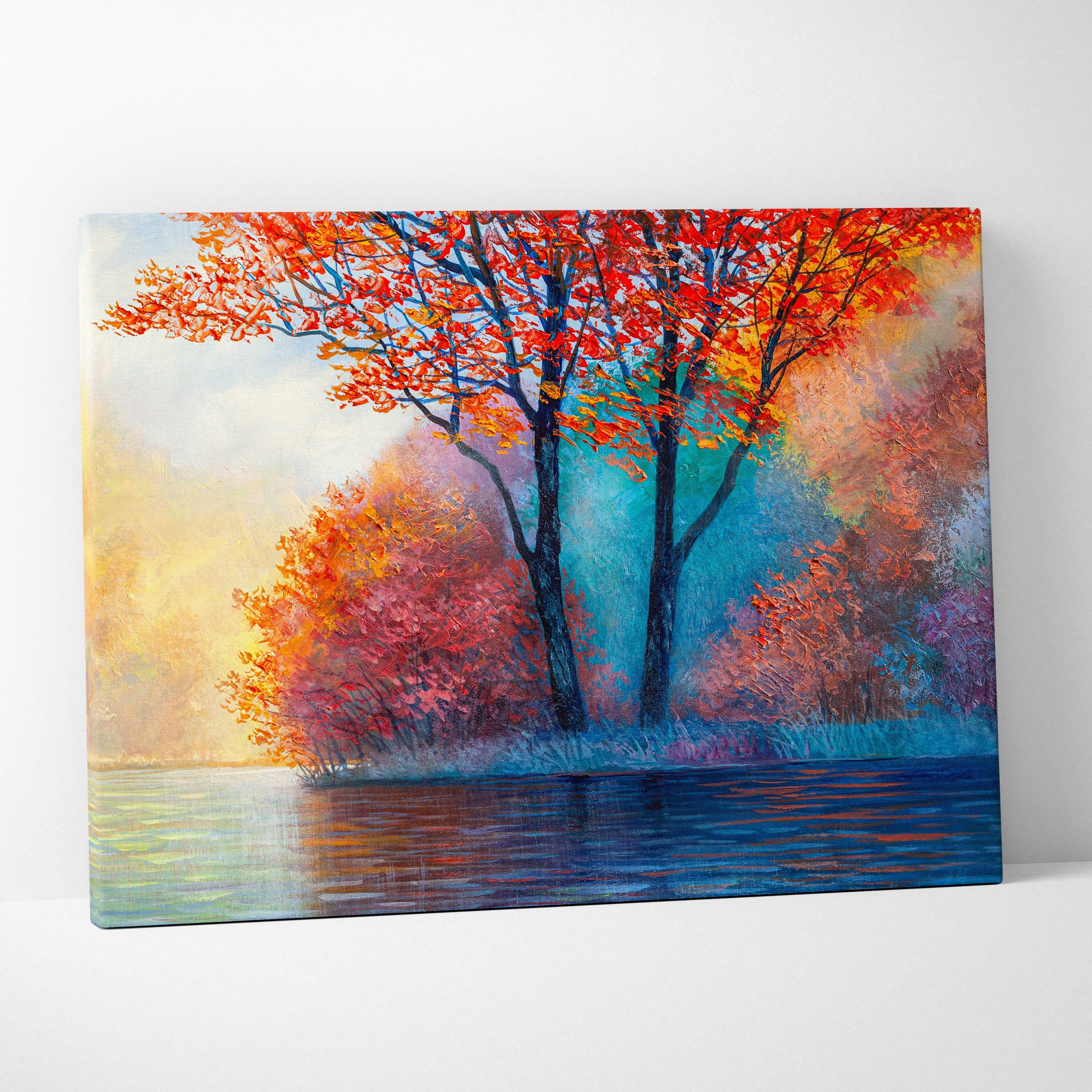 Vibrant autumn trees canvas print featuring bold red orange and pink foliage with blue water reflection wall art