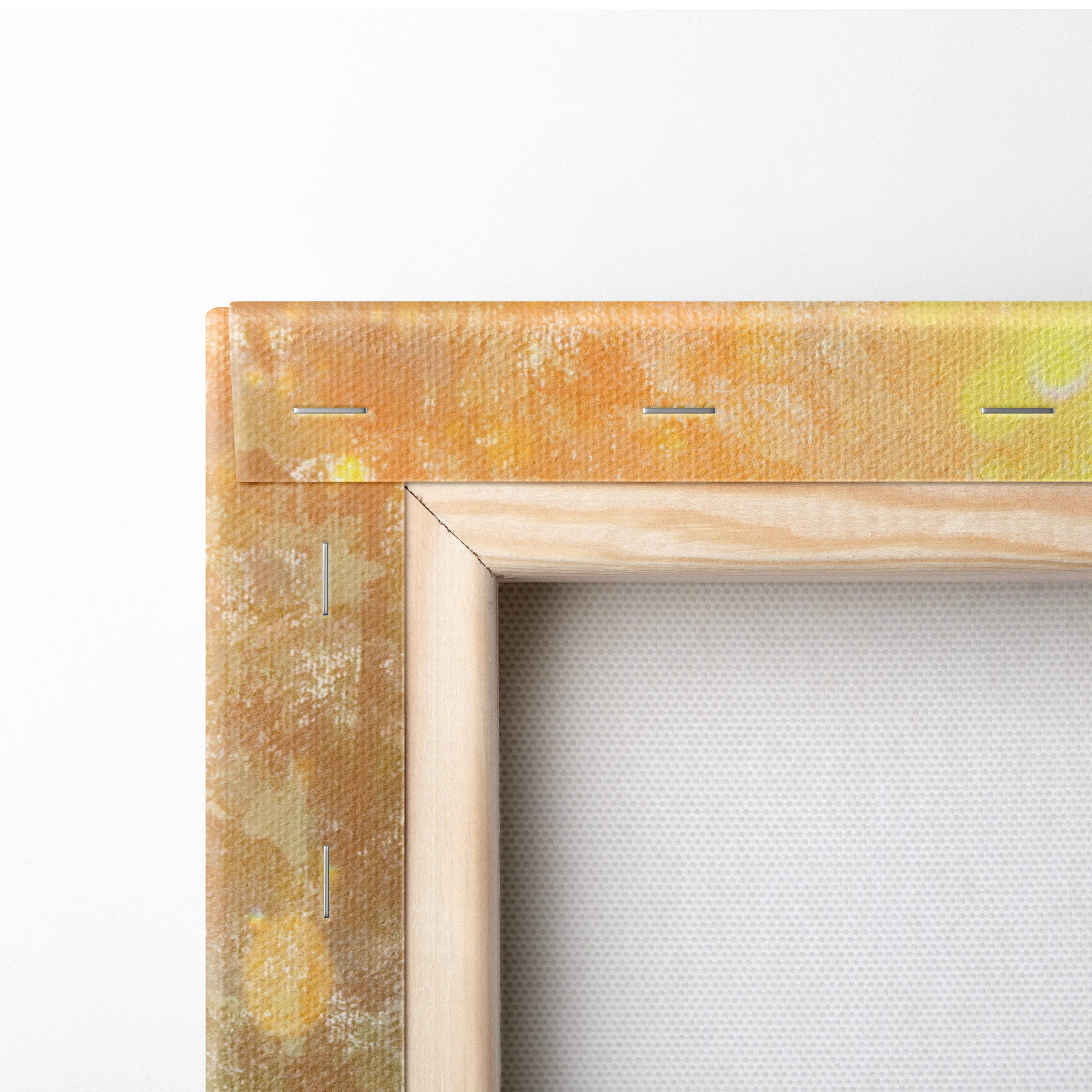 A rustic wooden canvas frame with textured golden yellow edges and visible stitching on the sunlit wildflower meadow print