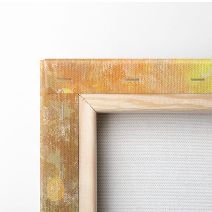 A rustic wooden canvas frame with textured golden yellow edges and visible stitching on the sunlit wildflower meadow print