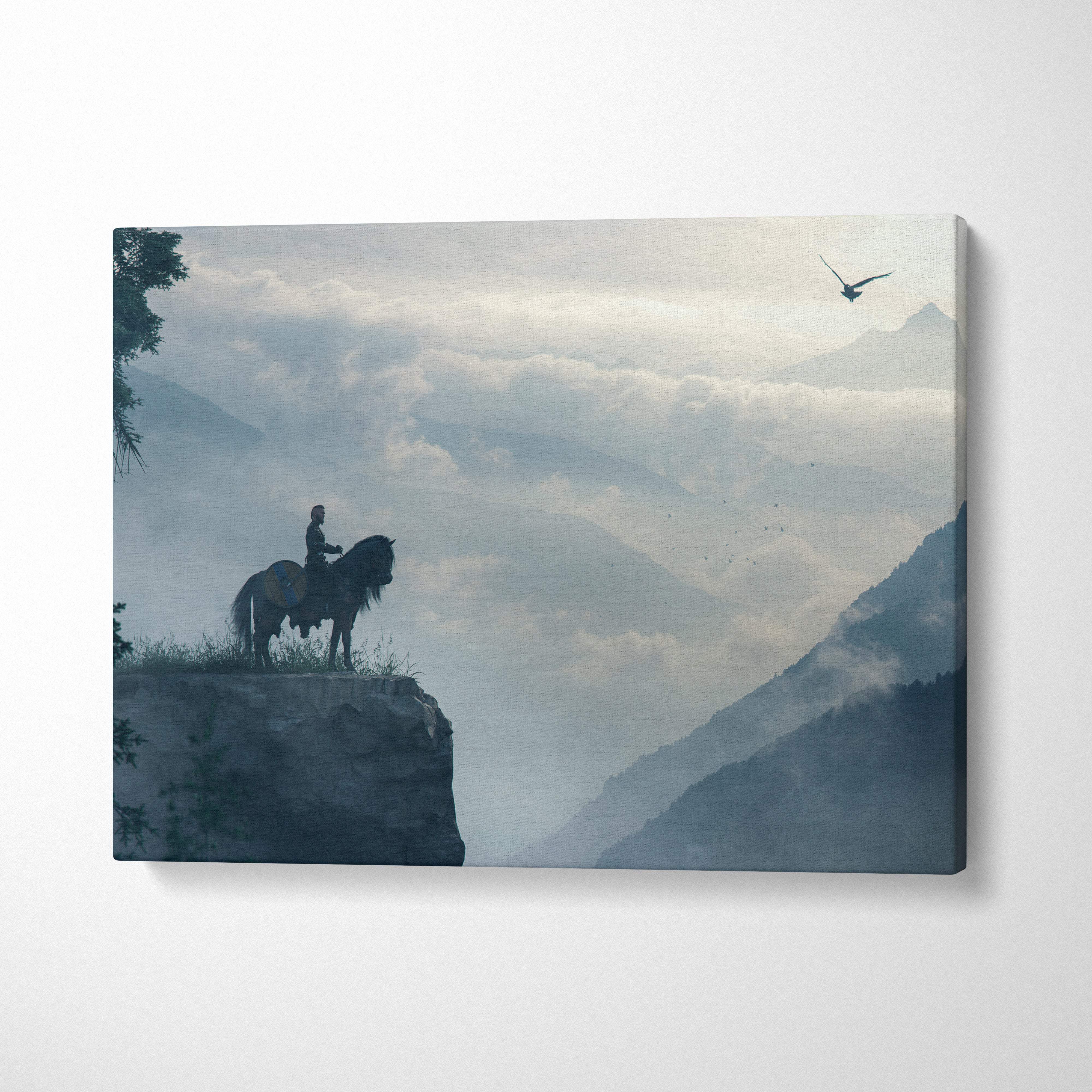 Rectangular canvas print of a lone rider on horseback silhouette with misty blue gray mountains in epic fantasy landscape wall decor