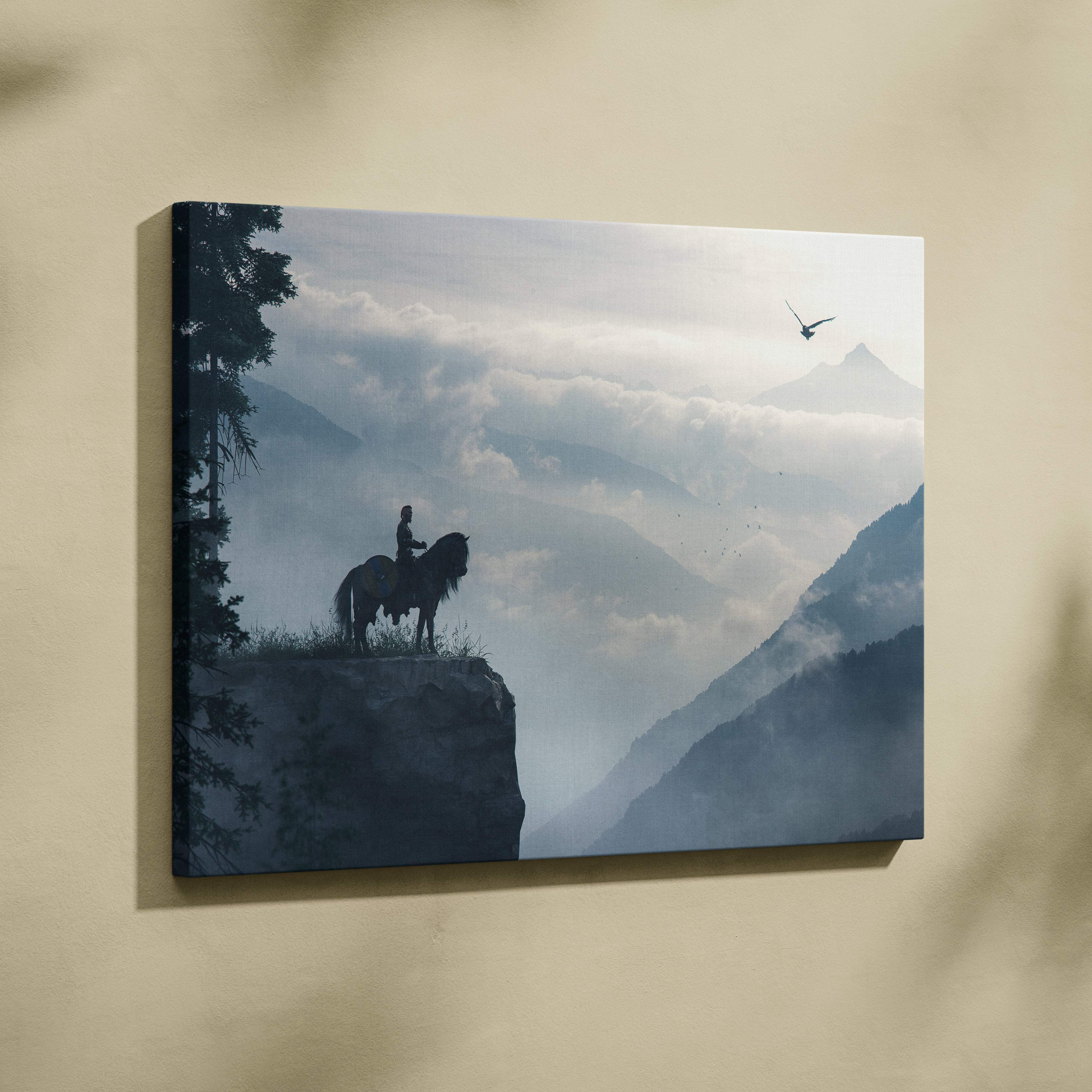 Lone rider mountain vista canvas art with a silhouette of rider on horseback on a cliff against misty peaks and flying eagle