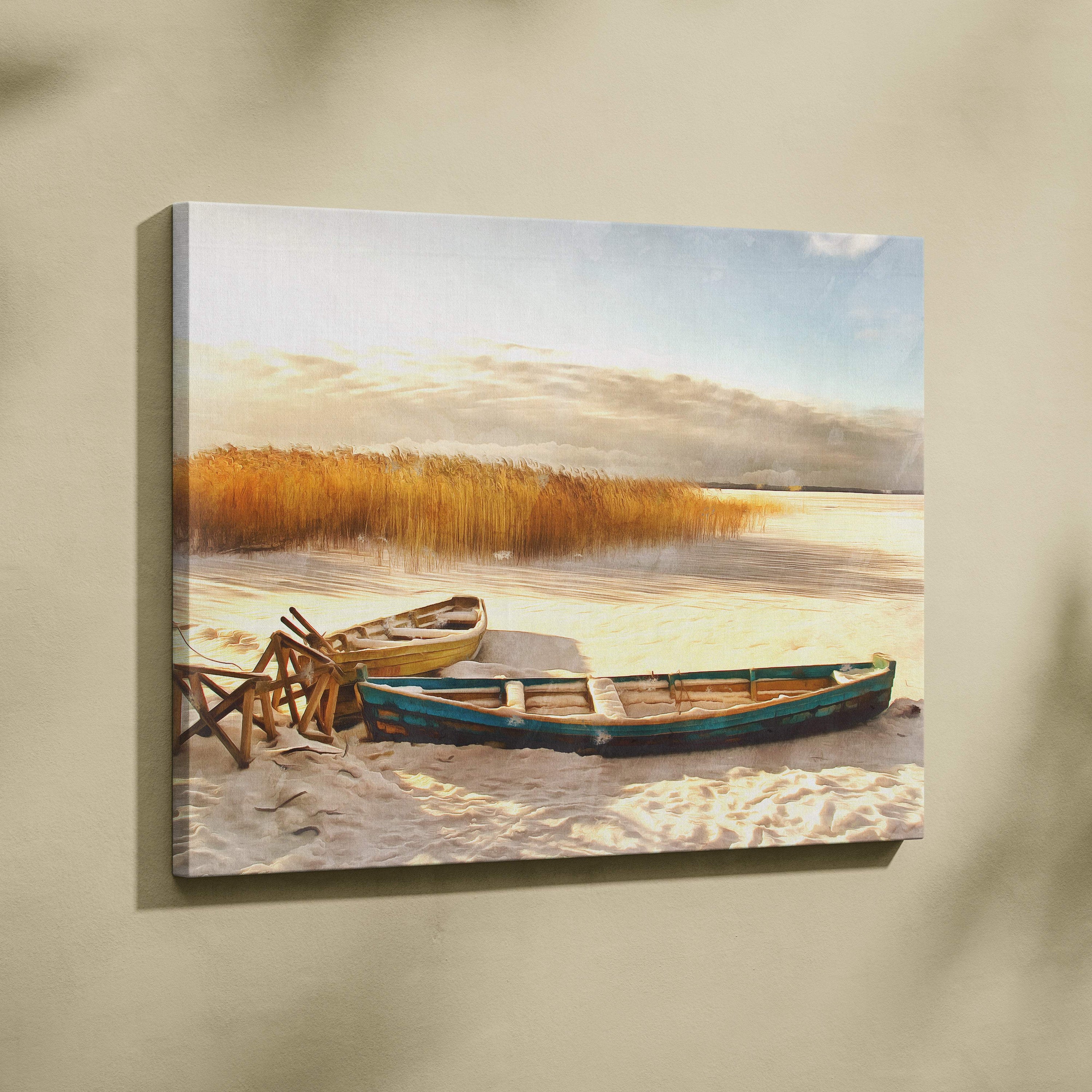 Canvas print of two weathered teal and yellow rowboats on a sandy shore with reeds in a golden winter lakeshore scene