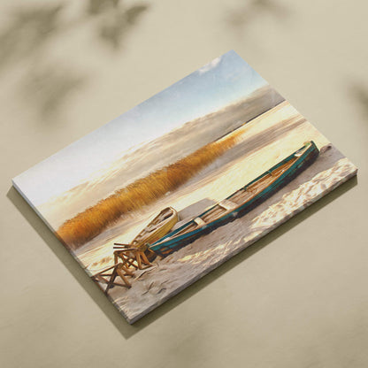 Rectangular canvas print of golden winter lakeshore with teal and yellow rowboats on sand beside reeds under soft sky