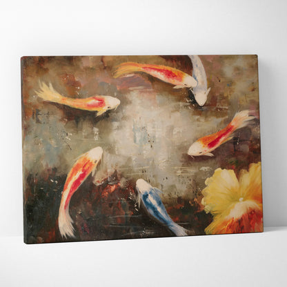 A canvas painting of graceful orange and white koi fish swimming in textured blue water with a yellow flower accent