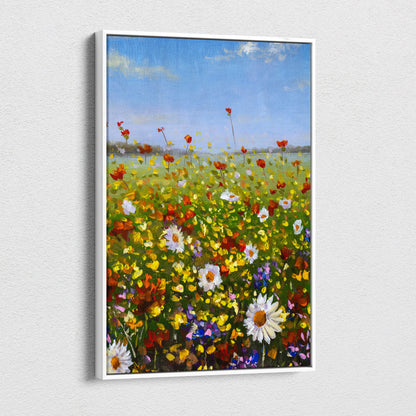 A vibrant wildflower meadow landscape canvas print with red poppies white daisies and blue sky in a sleek white frame