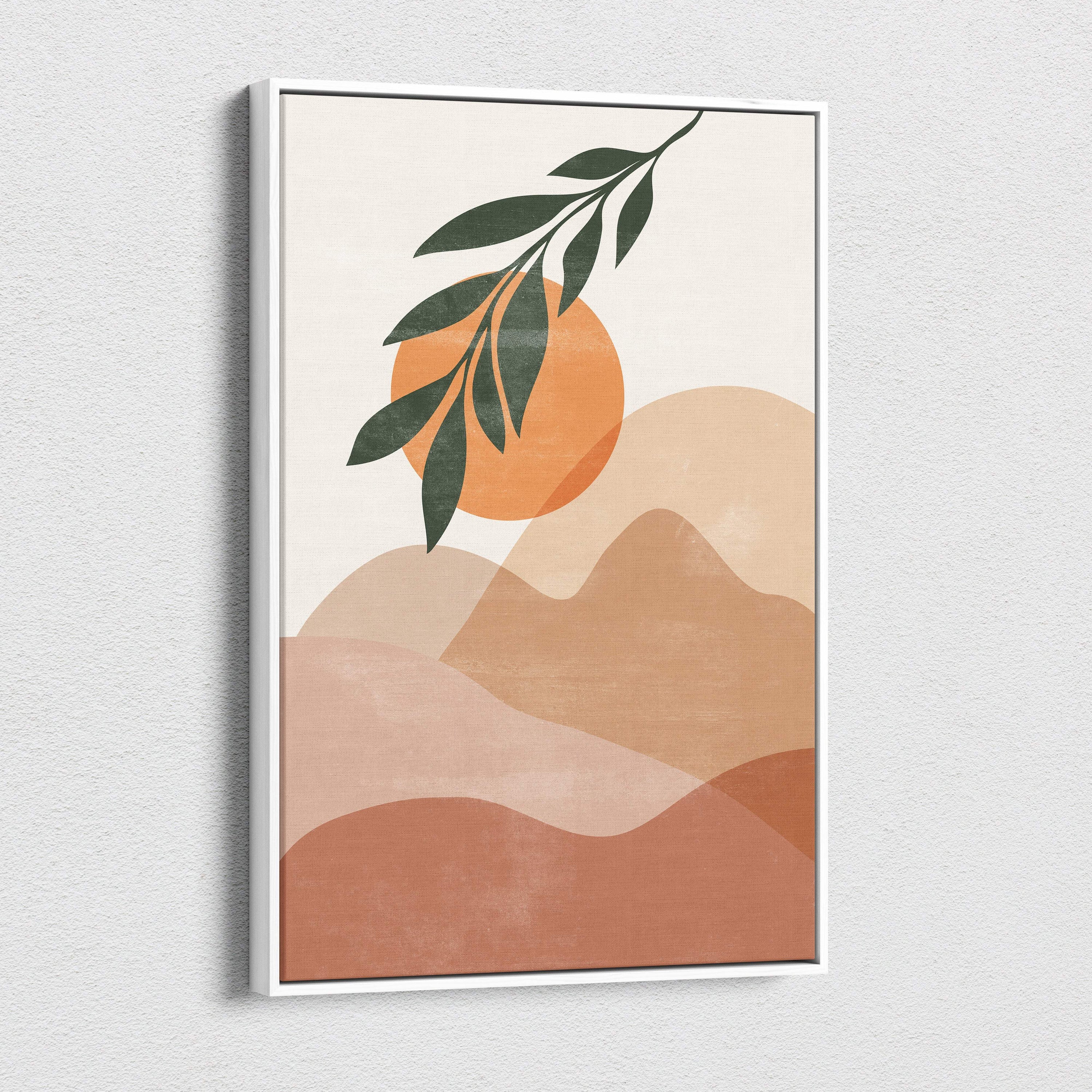 Modern minimalist framed art print featuring abstract desert landscape with terracotta hills sun and green botanical leaves