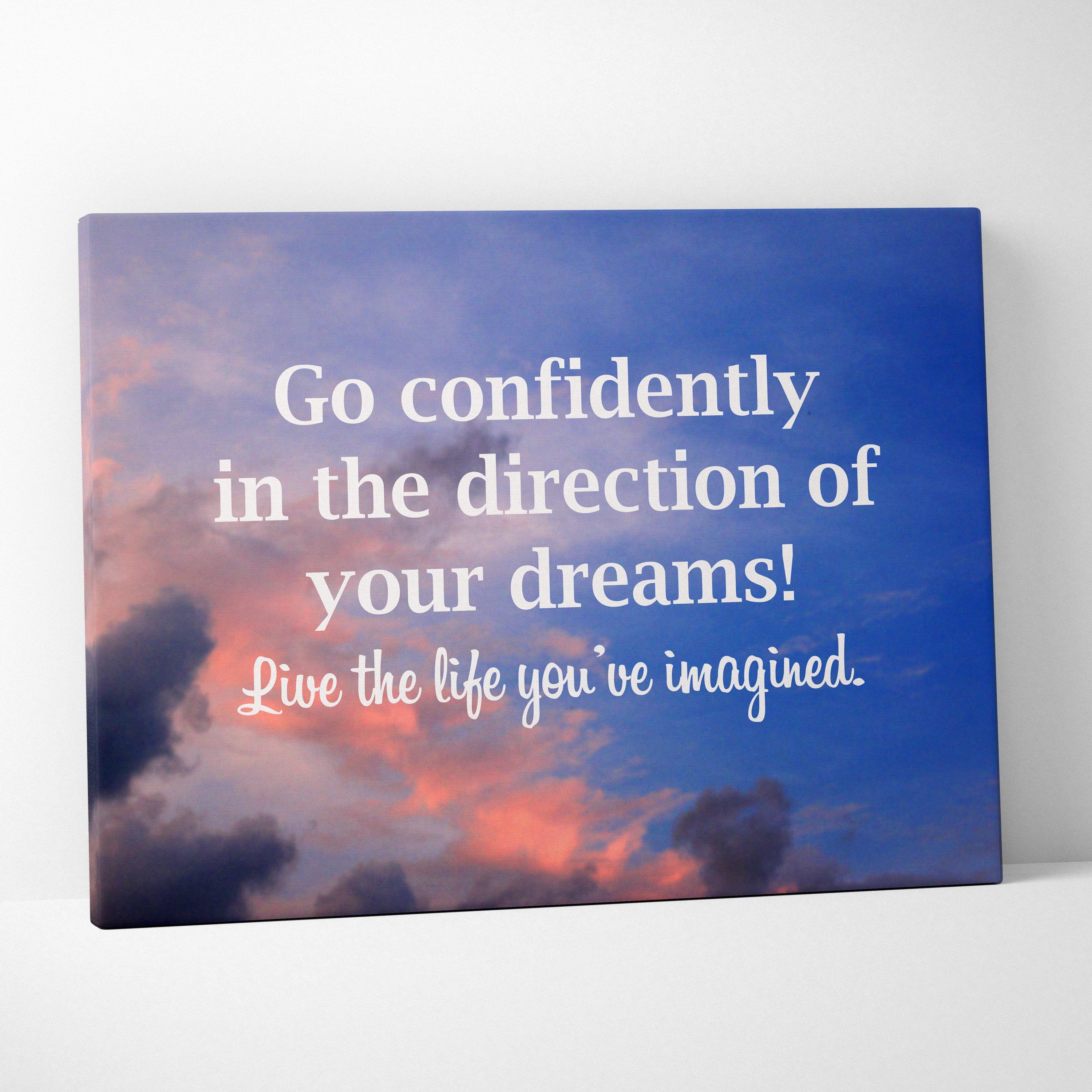 Blue canvas print with sunset sky and white motivational text go confidently in the direction of your dreams wall art