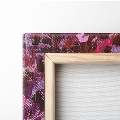 A wooden-framed canvas print with vibrant pink purple and deep red abstract design for wall art decoration