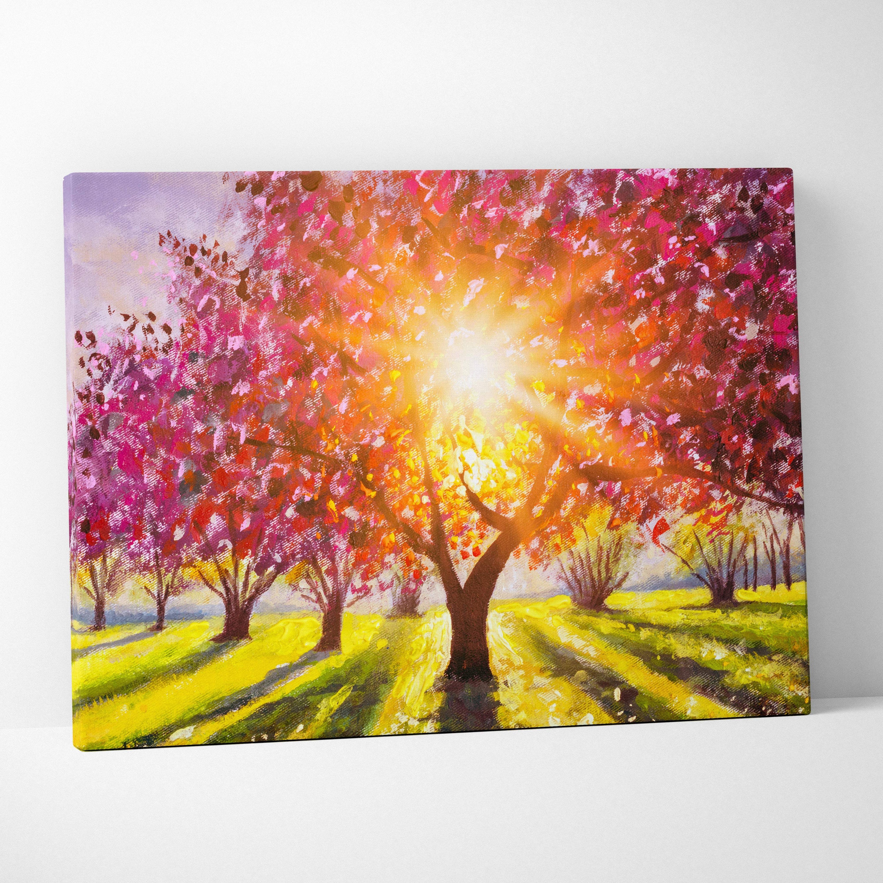 Vibrant canvas print of sunlit pink and orange blossom tree with golden light rays over bright yellow field landscape