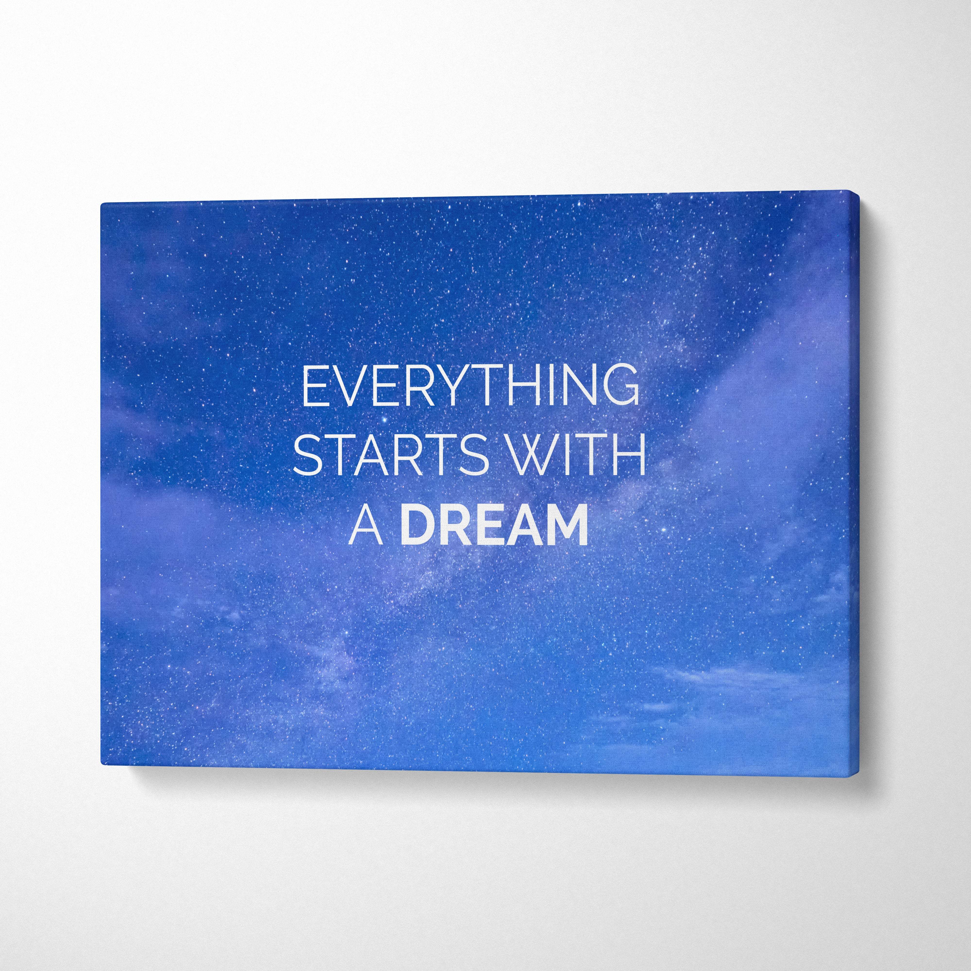 Blue canvas print with motivational everything starts with a dream white text on starry night sky for home or office decor