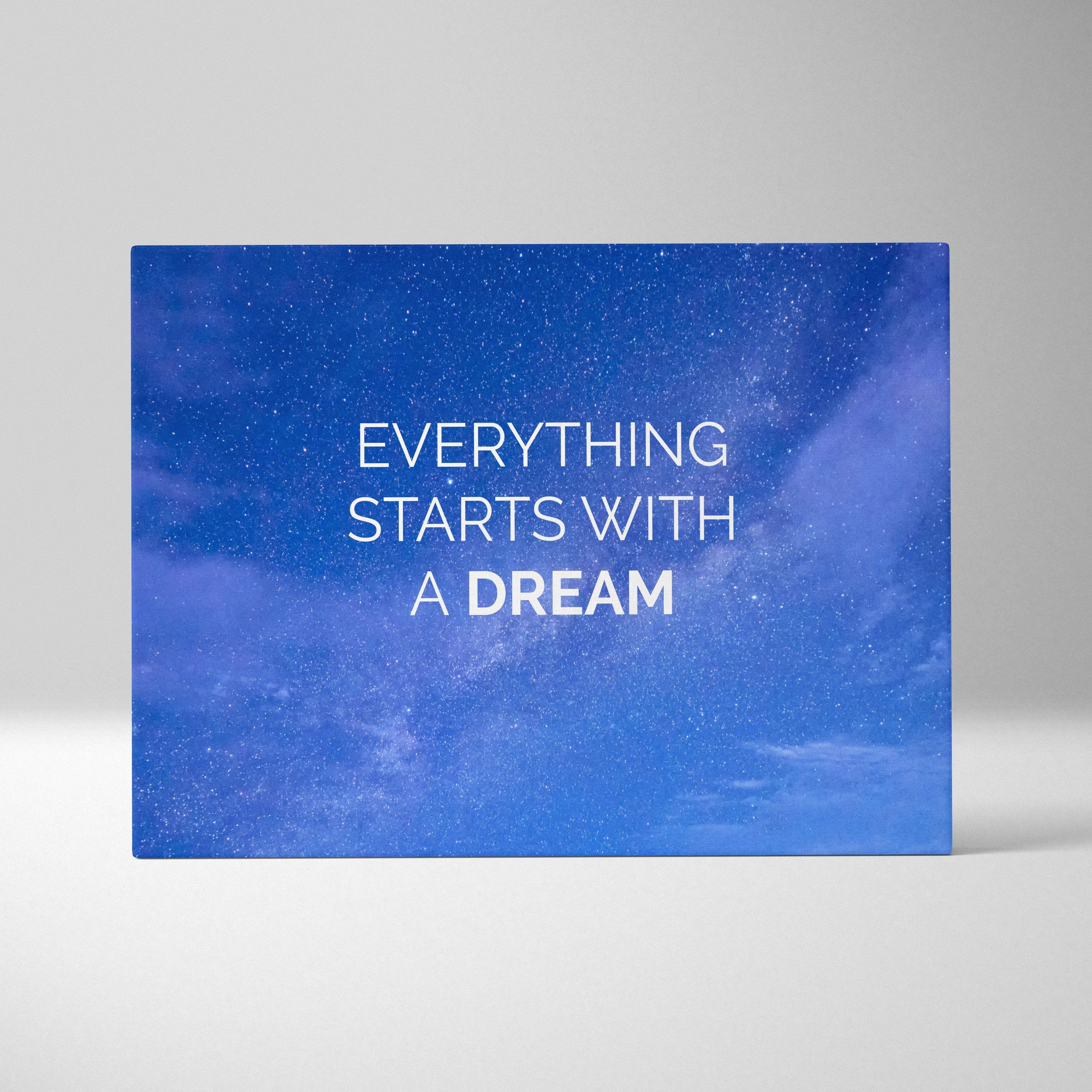 Blue canvas print with inspirational everything starts with a dream quote on starry night sky for home or office decor