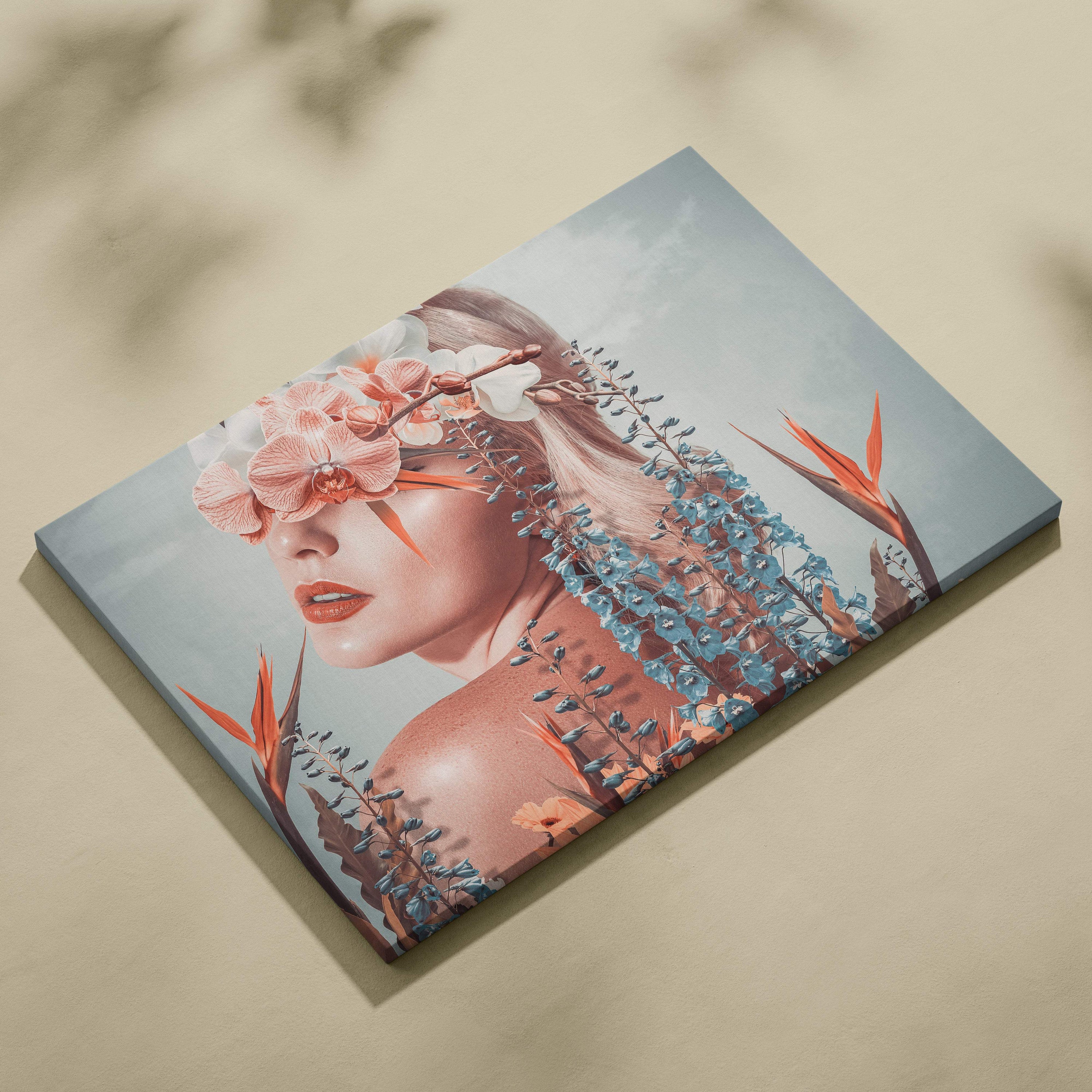 Rectangular canvas print of a woman with pink orchids blue wisteria and orange bird-of-paradise flowers on gray background