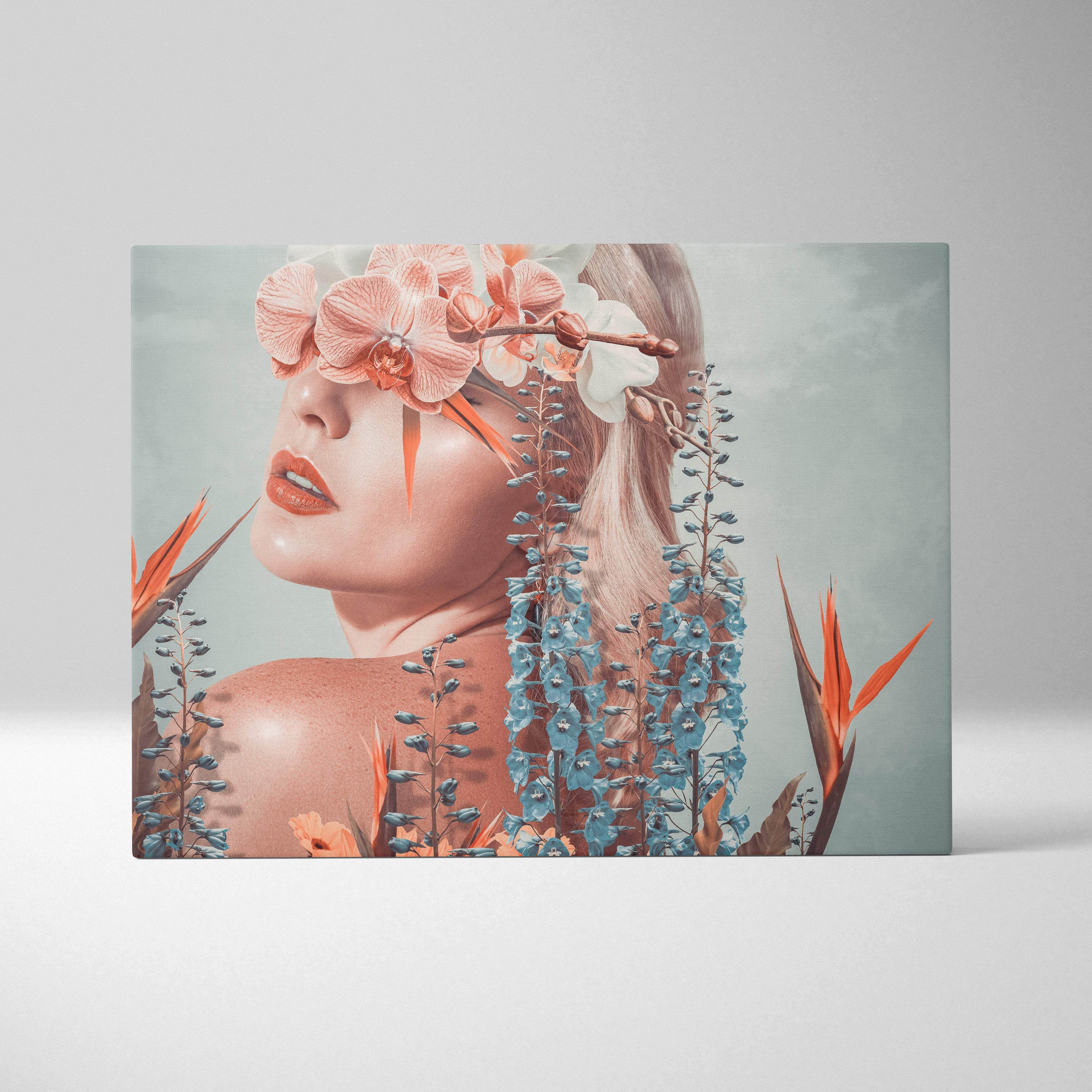 Rectangular canvas print of a woman with pink and white orchids over eyes surrounded by blue and orange tropical flowers