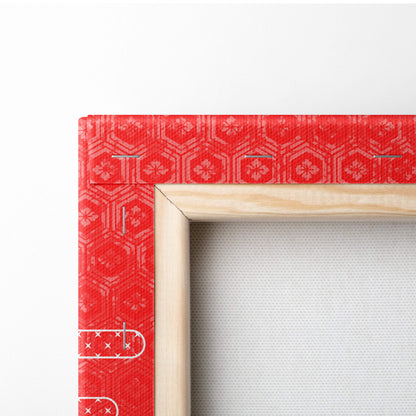 Red patterned fabric-covered wooden picture frame corner with traditional geometric and floral motifs for wall art