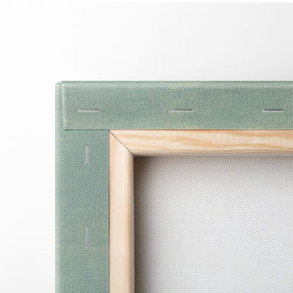 A light green canvas print with natural wood border featuring sunlit wildflower field and winding road landscape art