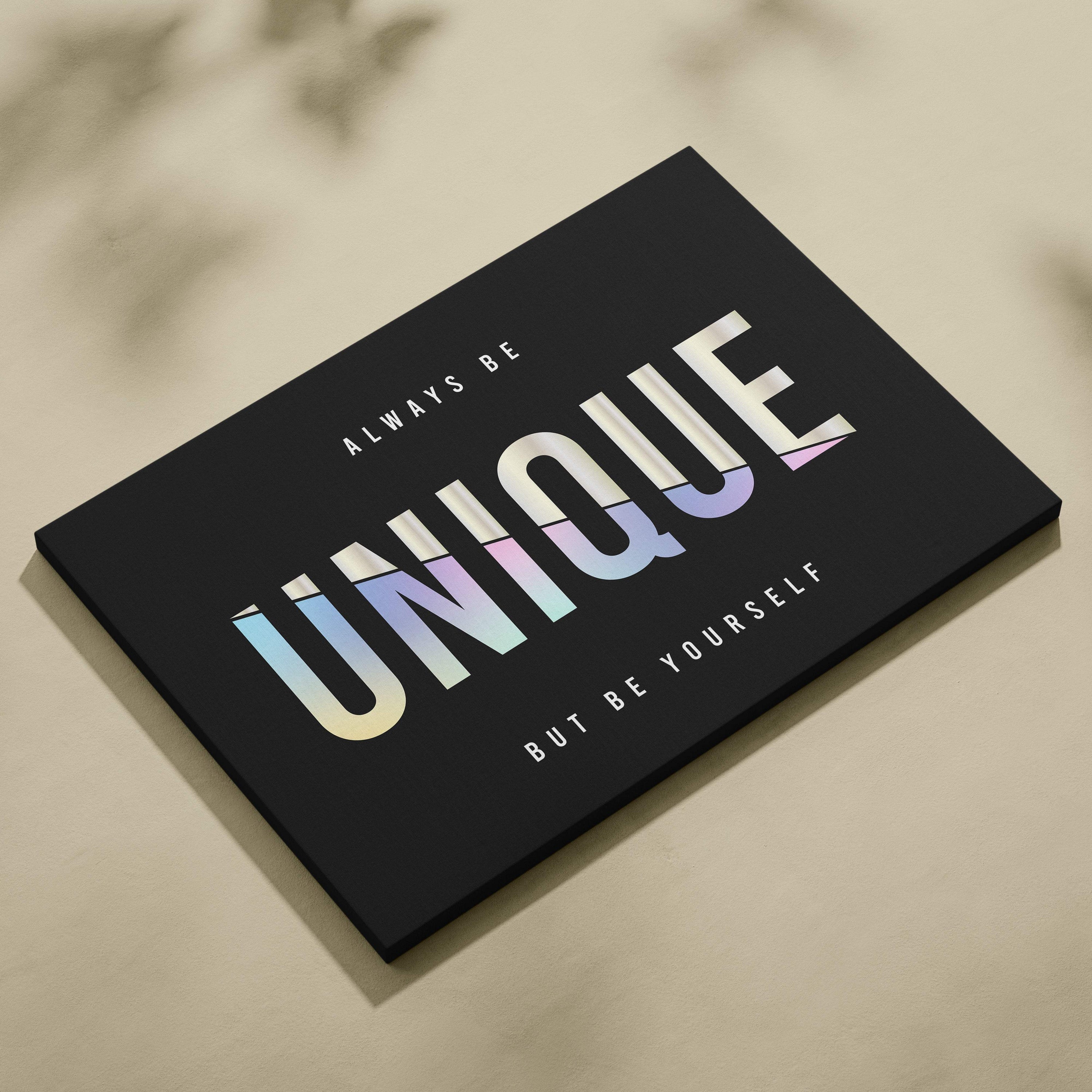 Black canvas print featuring the word unique in bold iridescent gradient with motivational text for bedroom or office decor