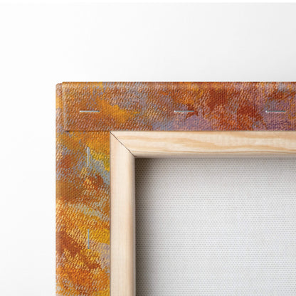 A rustic canvas print mounted in a light wood frame featuring a warm orange and rust abstract pattern