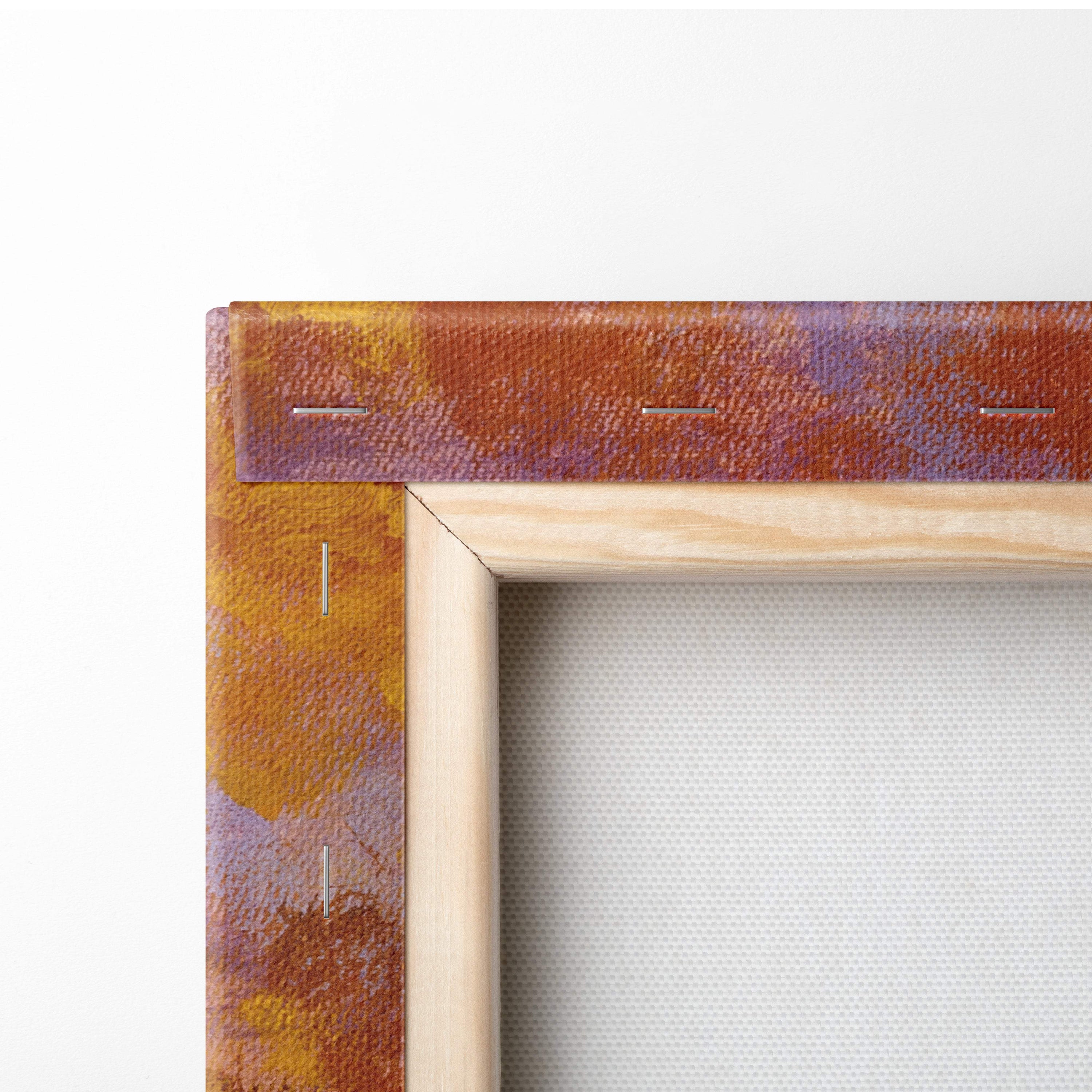 A radiant sunset flower field canvas print with textured orange and purple hues in a light wooden frame