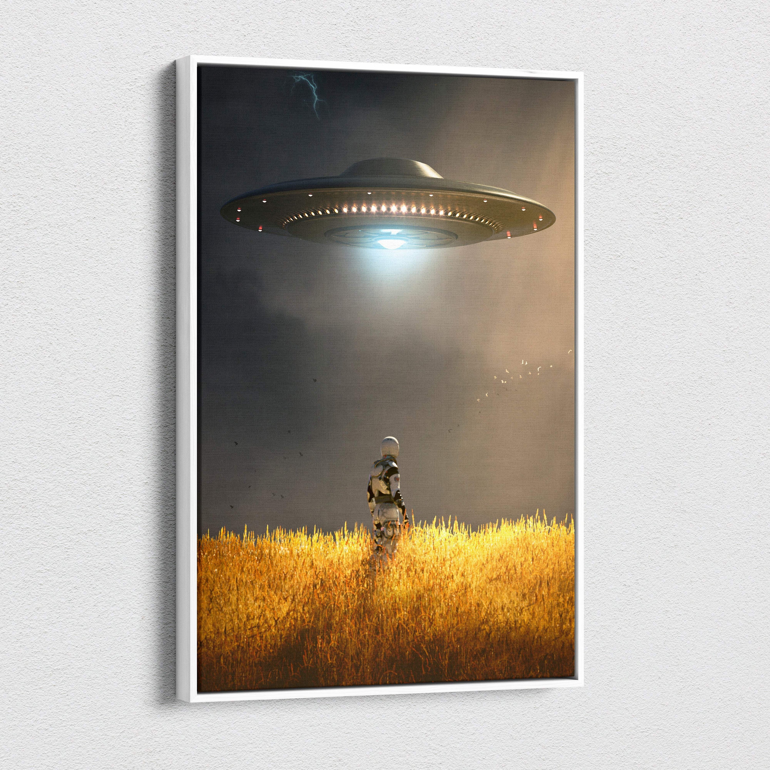 A framed canvas artwork of a dark metallic ufo over golden wheat fields with an astronaut under a dramatic sky