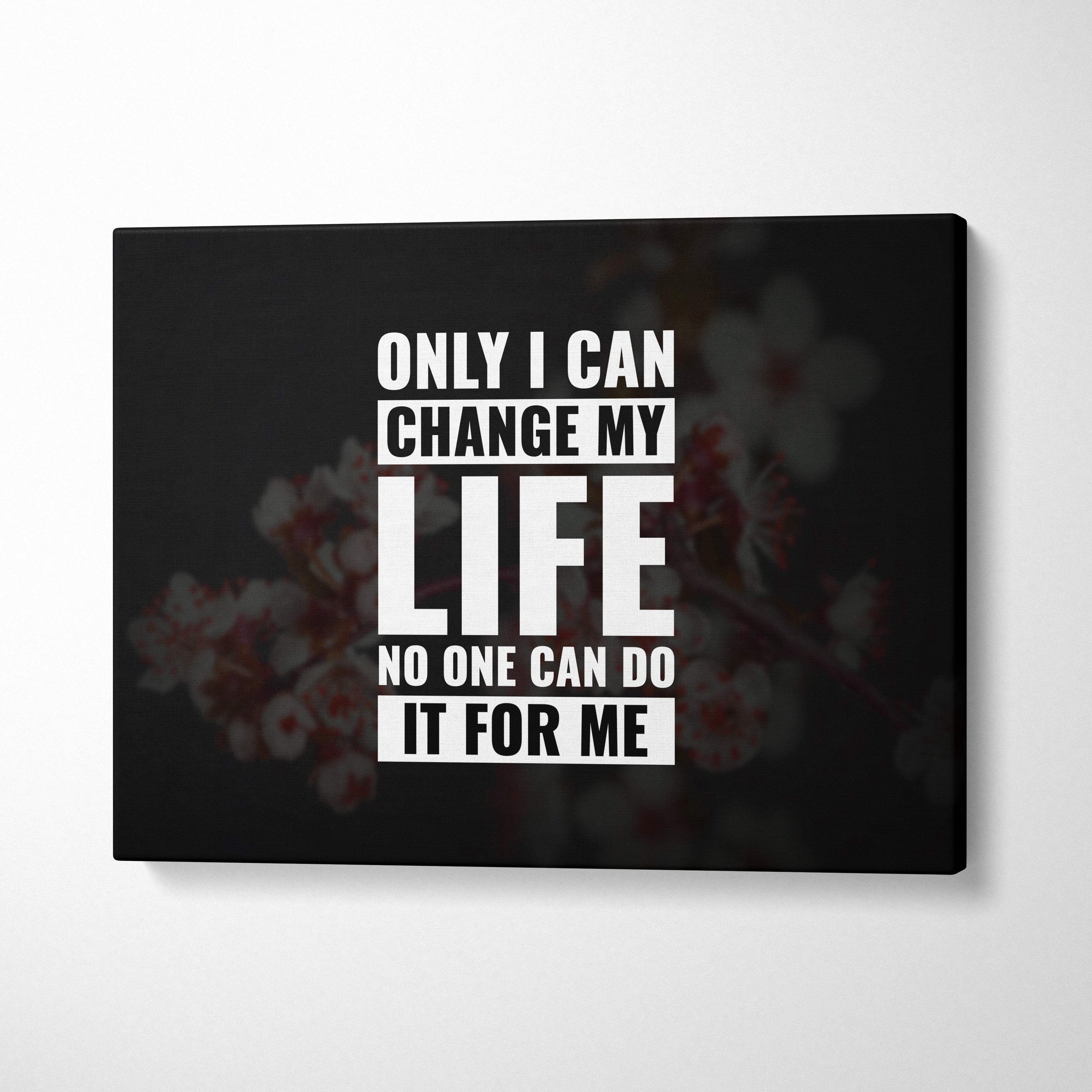 Black canvas print with bold white motivational text featuring a blurred floral background for positive mindset decor