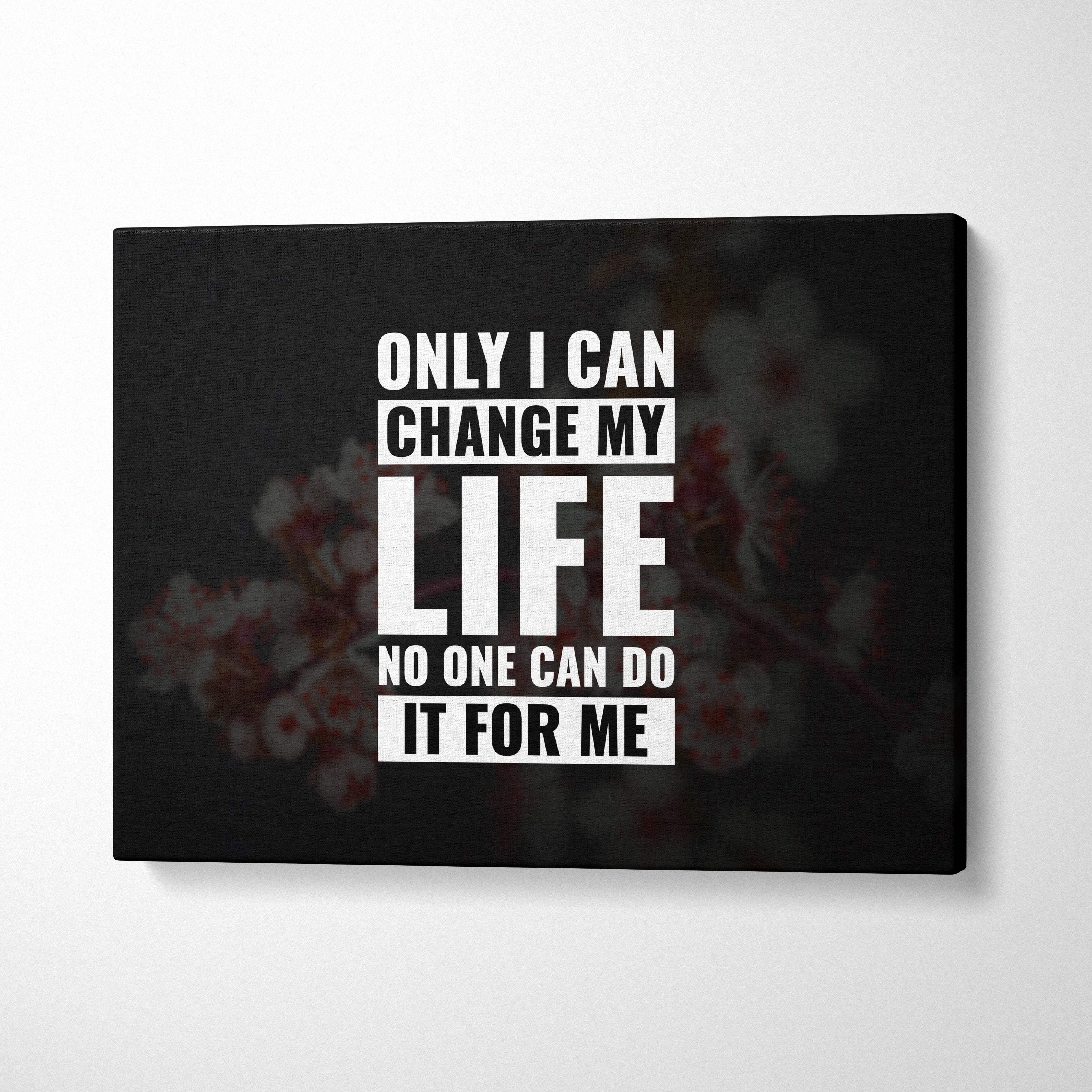 Black canvas print with bold white motivational text featuring a blurred floral background for positive mindset decor