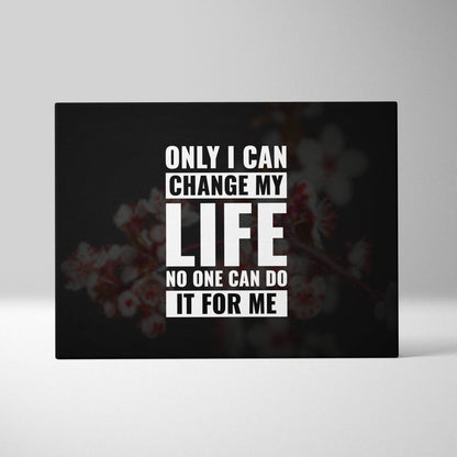 Black rectangular canvas print with bold white motivational text on blurred floral background for bedroom or office decor