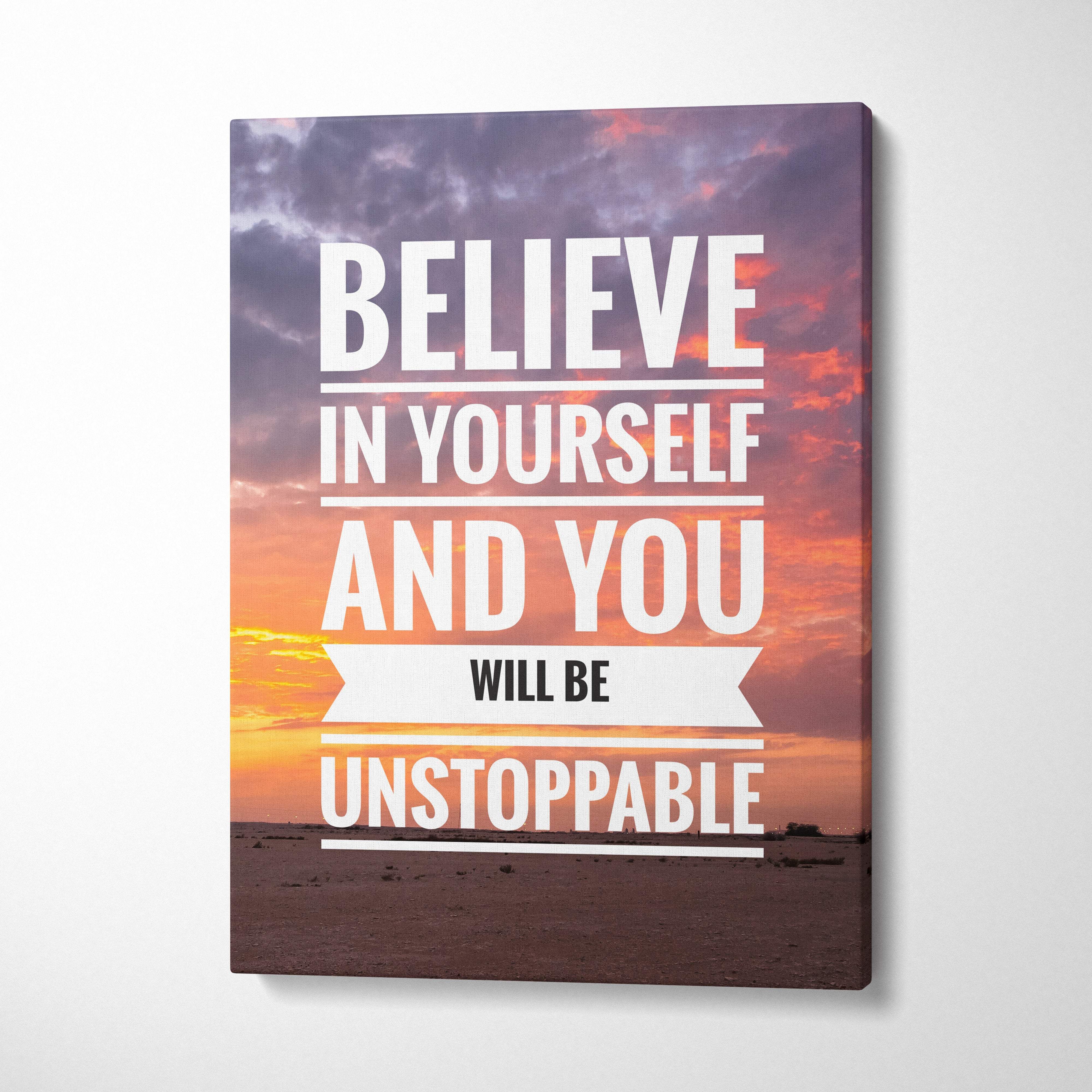 Motivational canvas print with believe in yourself quote over vibrant orange pink and purple sunset sky for office decor
