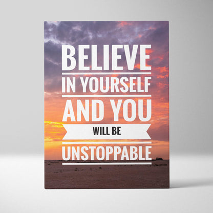 A rectangular canvas print with a motivational believe in yourself quote in white on a vibrant sunset sky background