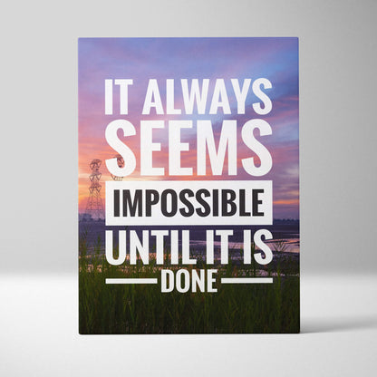 Rectangular canvas print with it always seems impossible until it is done quote in white and black over sunset landscape