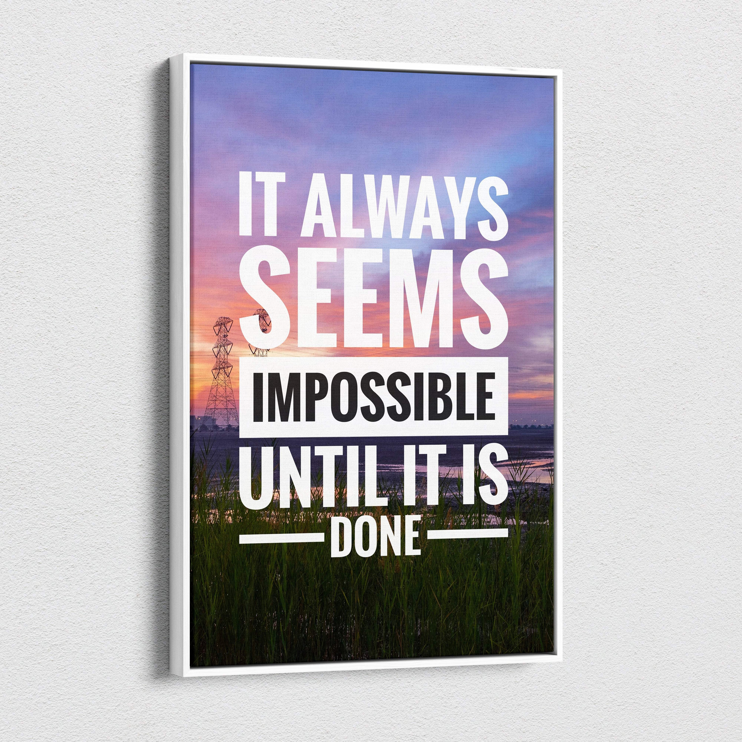 White-framed canvas print featuring the motivational quote it always seems impossible until it is done on a sunset landscape