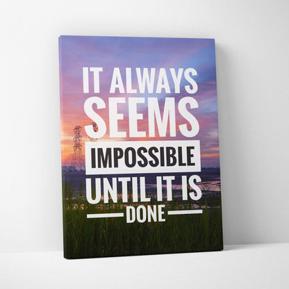 A rectangular canvas print featuring a motivational quote in bold white and black lettering on a colorful sunset landscape background