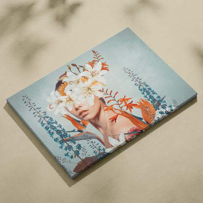 A rectangular canvas print of a woman with white lilies and orange teal foliage on a soft blue background for bedroom decor