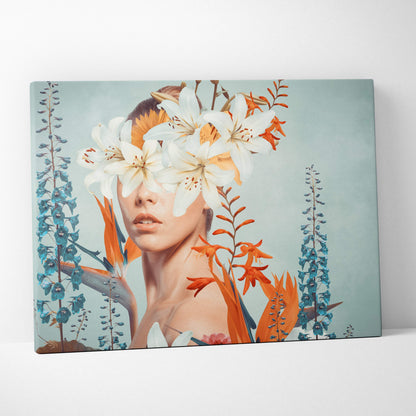 A rectangular canvas print featuring a woman’s face with white lilies and orange flowers on a teal background for bedroom decor
