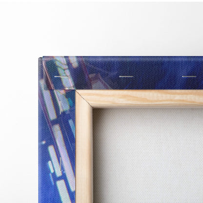 Light-colored wooden frame holding a canvas print with abstract blue and white cyberpunk neon motorcycle art