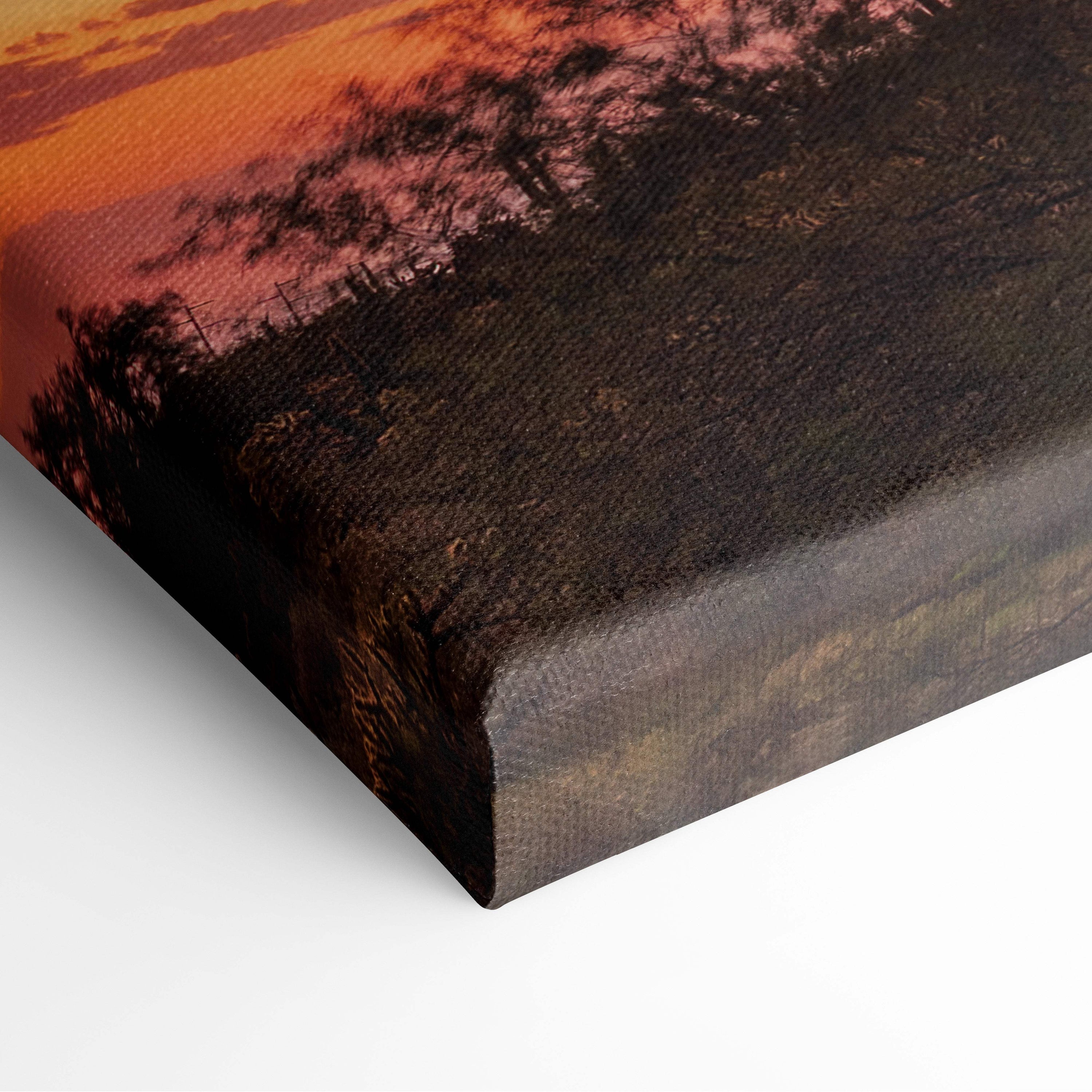 Canvas print featuring a purple sunset sky with cactus landscape in warm orange and deep brown tones on textured canvas