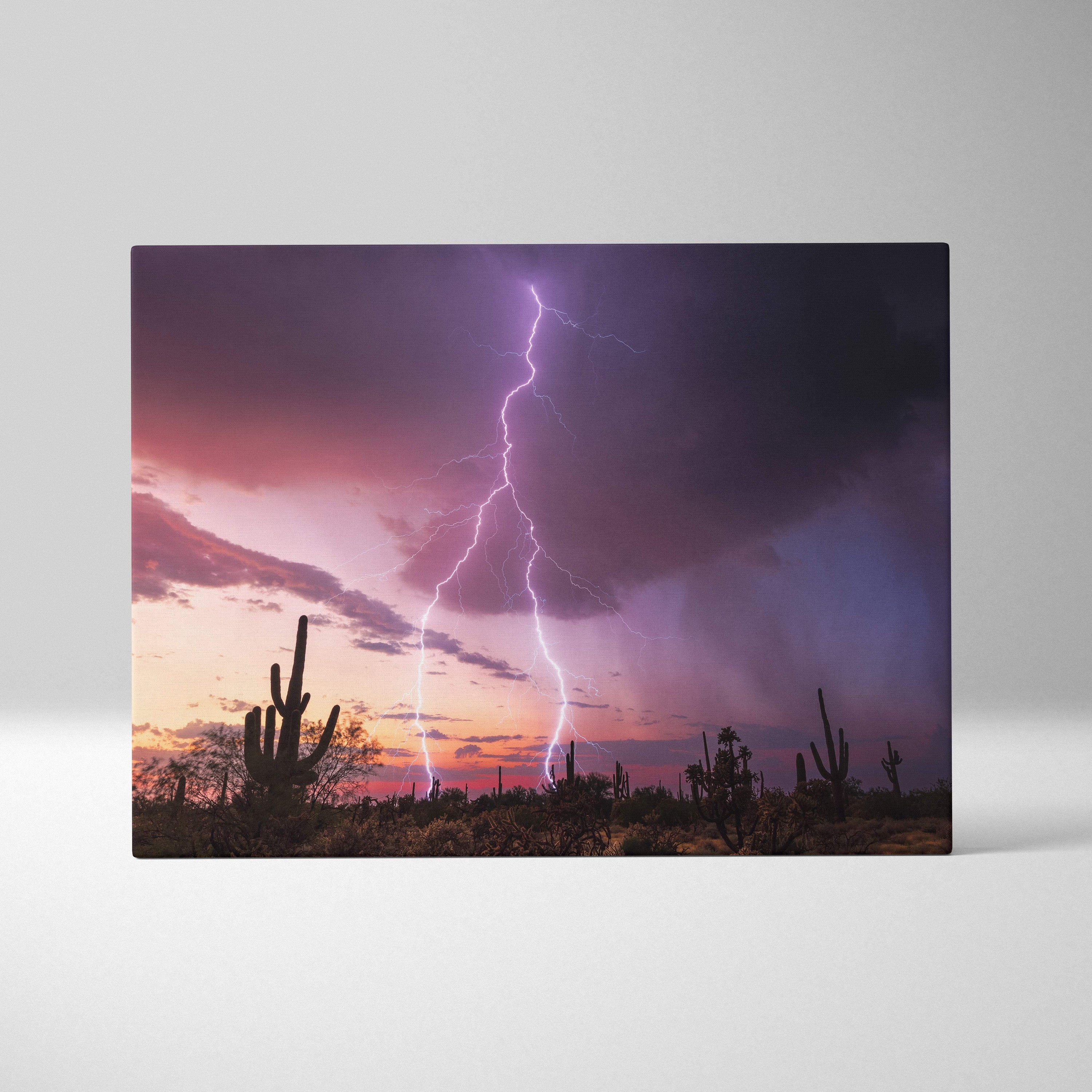 Rectangular canvas print of desert lightning storm with purple and pink sky and silhouetted cactus landscape wall decor