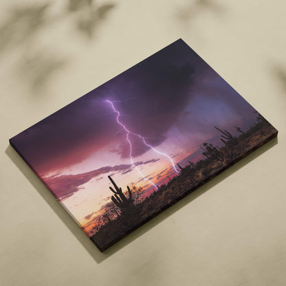 Desert lightning storm canvas art featuring a vivid purple and orange lightning strike with silhouetted cacti below