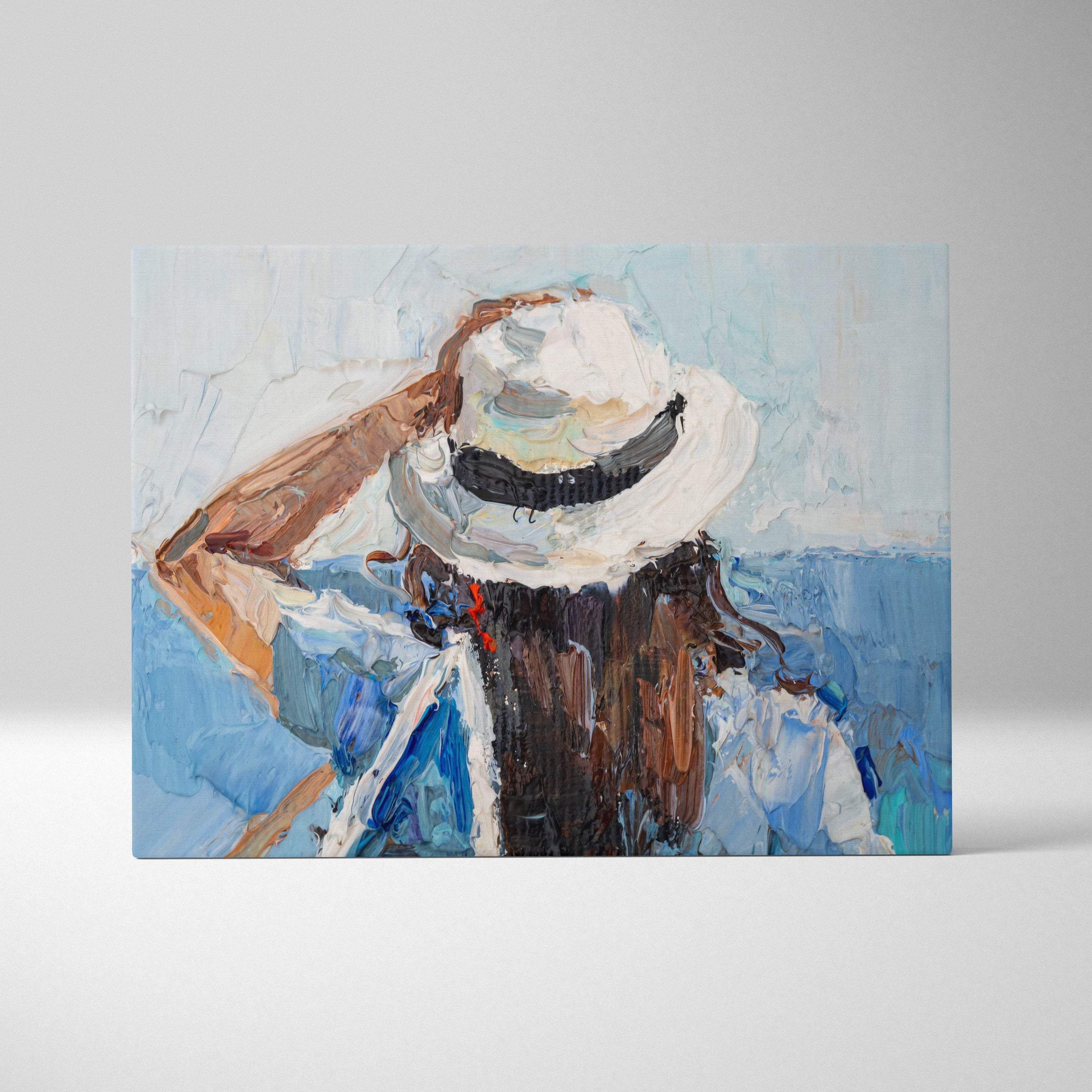 Textured canvas wall art print of a person from behind wearing a white hat with black band for coastal decor