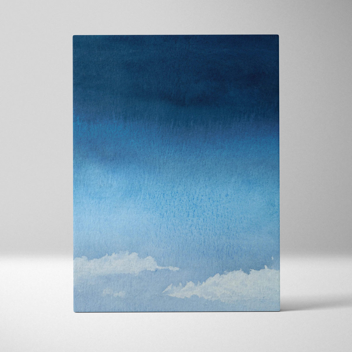 Minimalist watercolor sky canvas with deep navy to pale blue gradient and soft white clouds