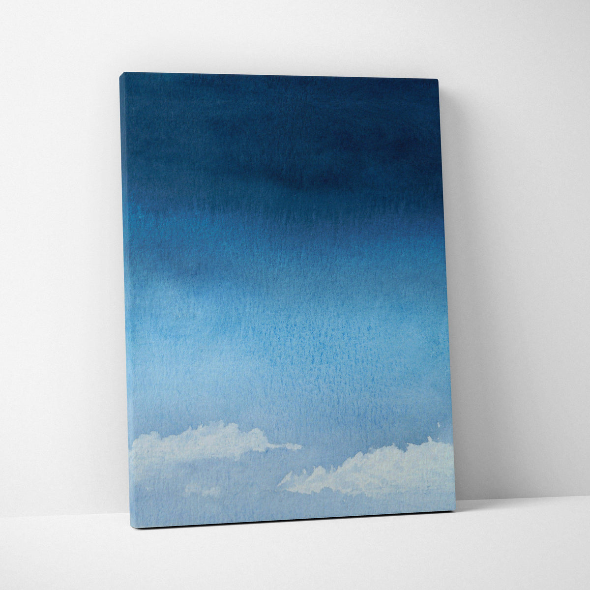 Minimalist watercolor sky canvas art with deep navy to pale blue gradient and soft white clouds