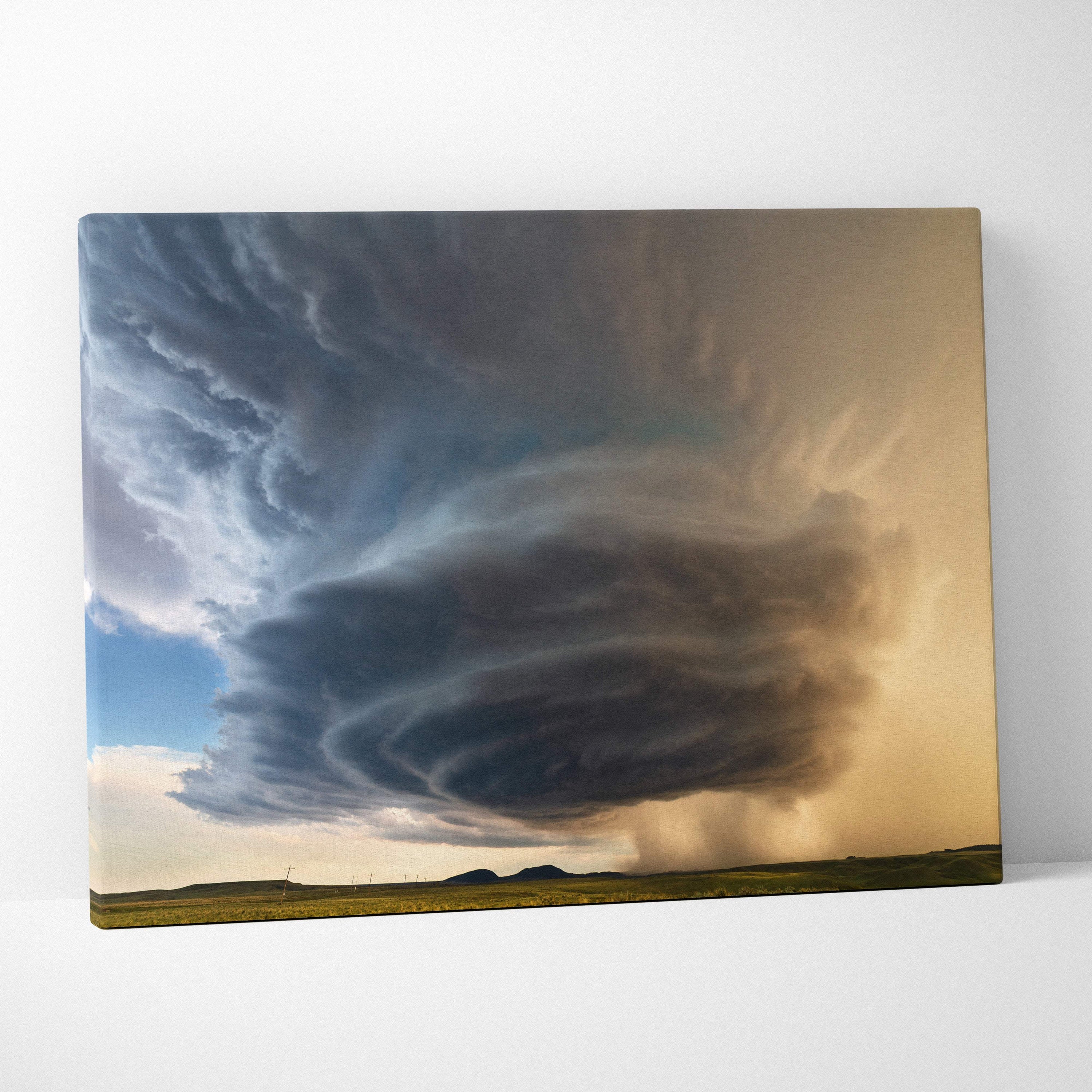 Supercell thunderstorm canvas art showing dramatic swirling dark storm clouds against a golden sky landscape wall decor