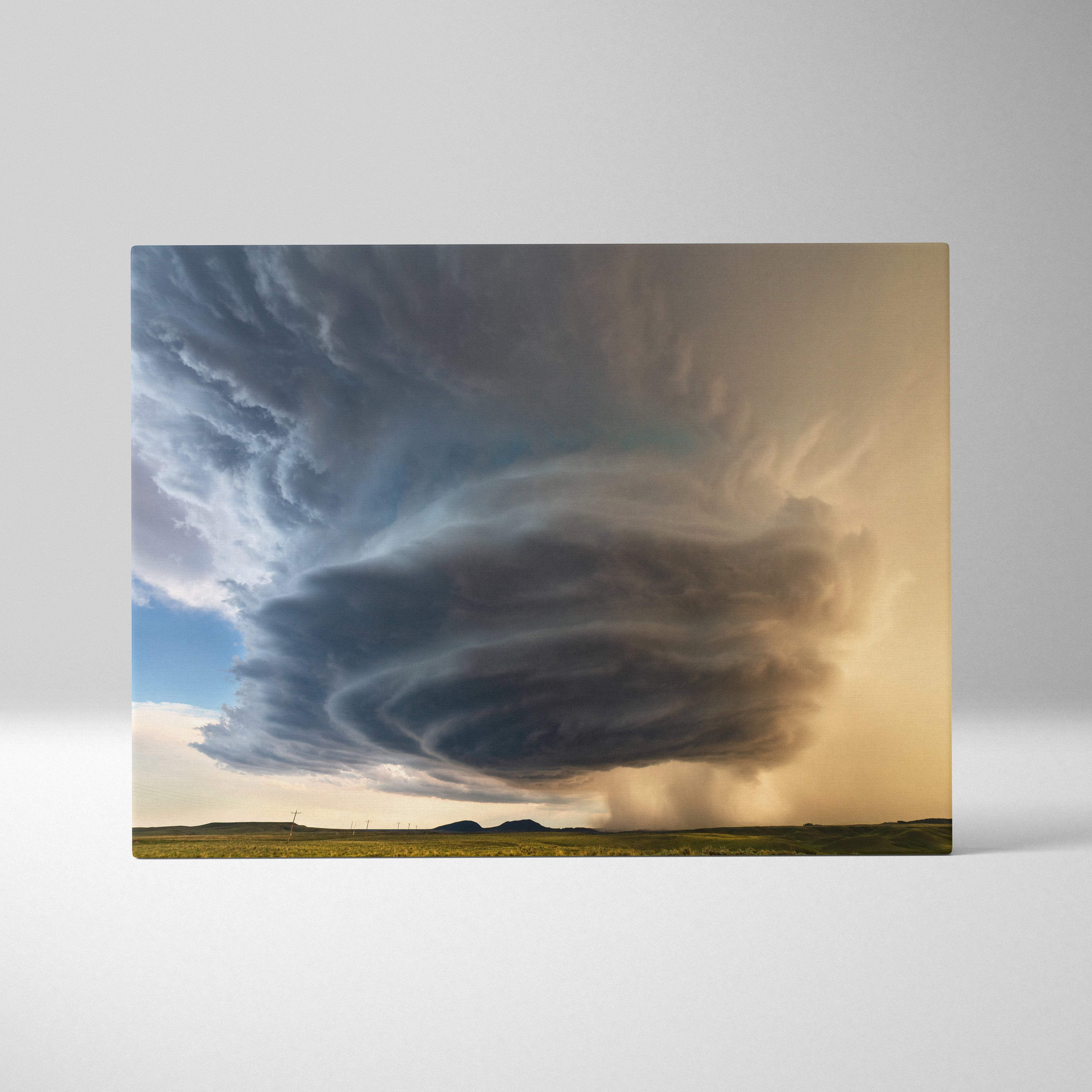 Rectangular canvas art of a dramatic swirling supercell thunderstorm with dark clouds over a green field and golden sky