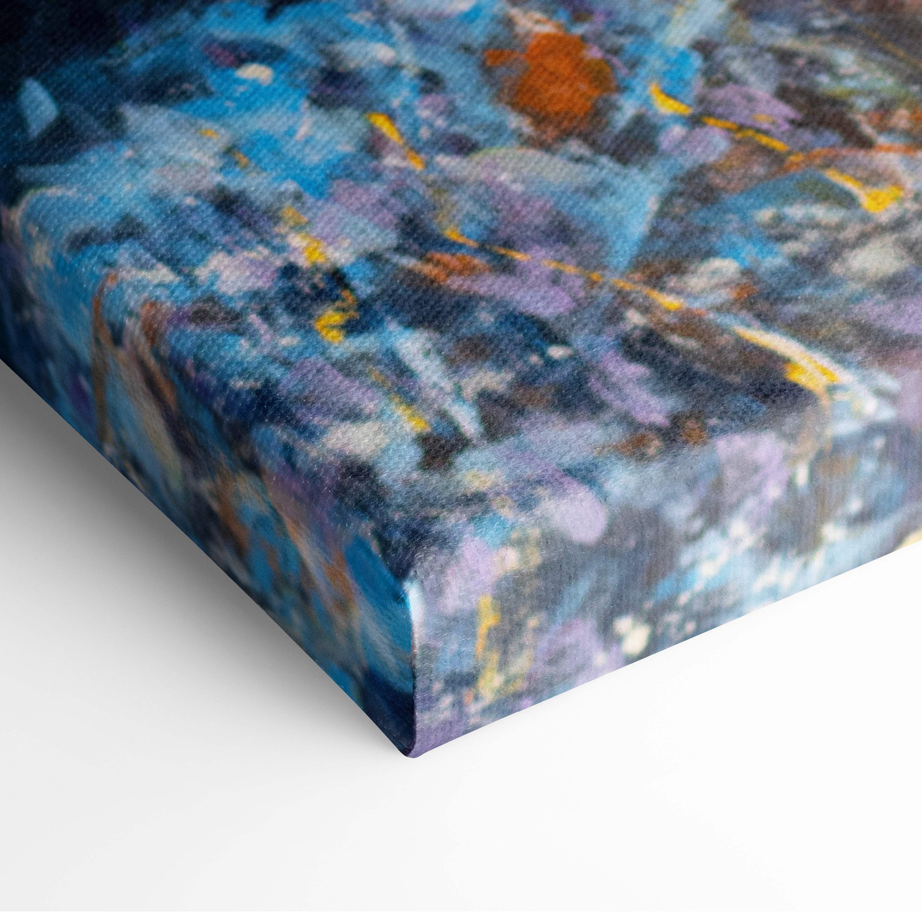 Ocean sunset waves canvas print featuring vibrant blue purple and yellow splashes on textured fabric surface