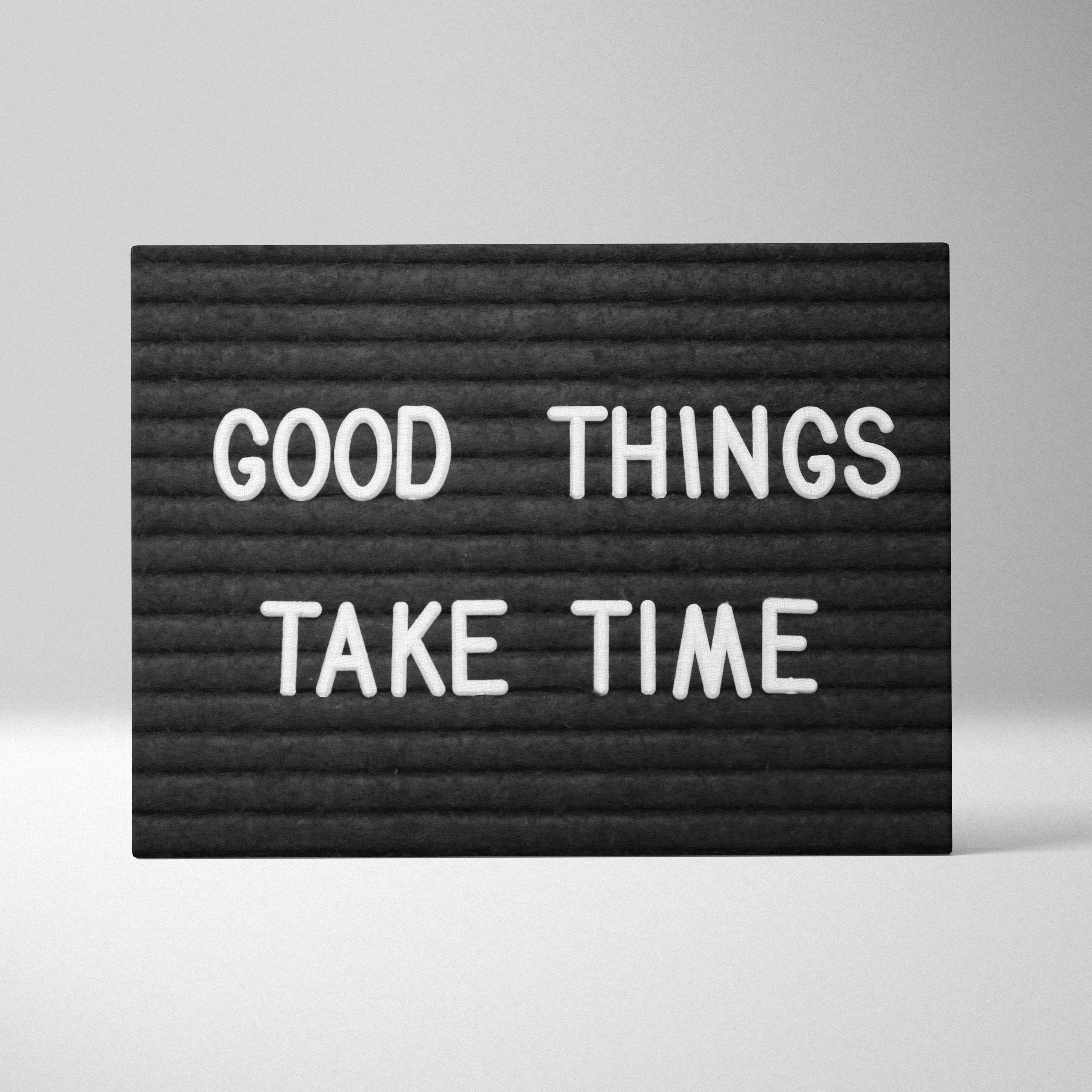 Minimalist black letterboard with white raised letters spelling good things take time motivational wall art decor