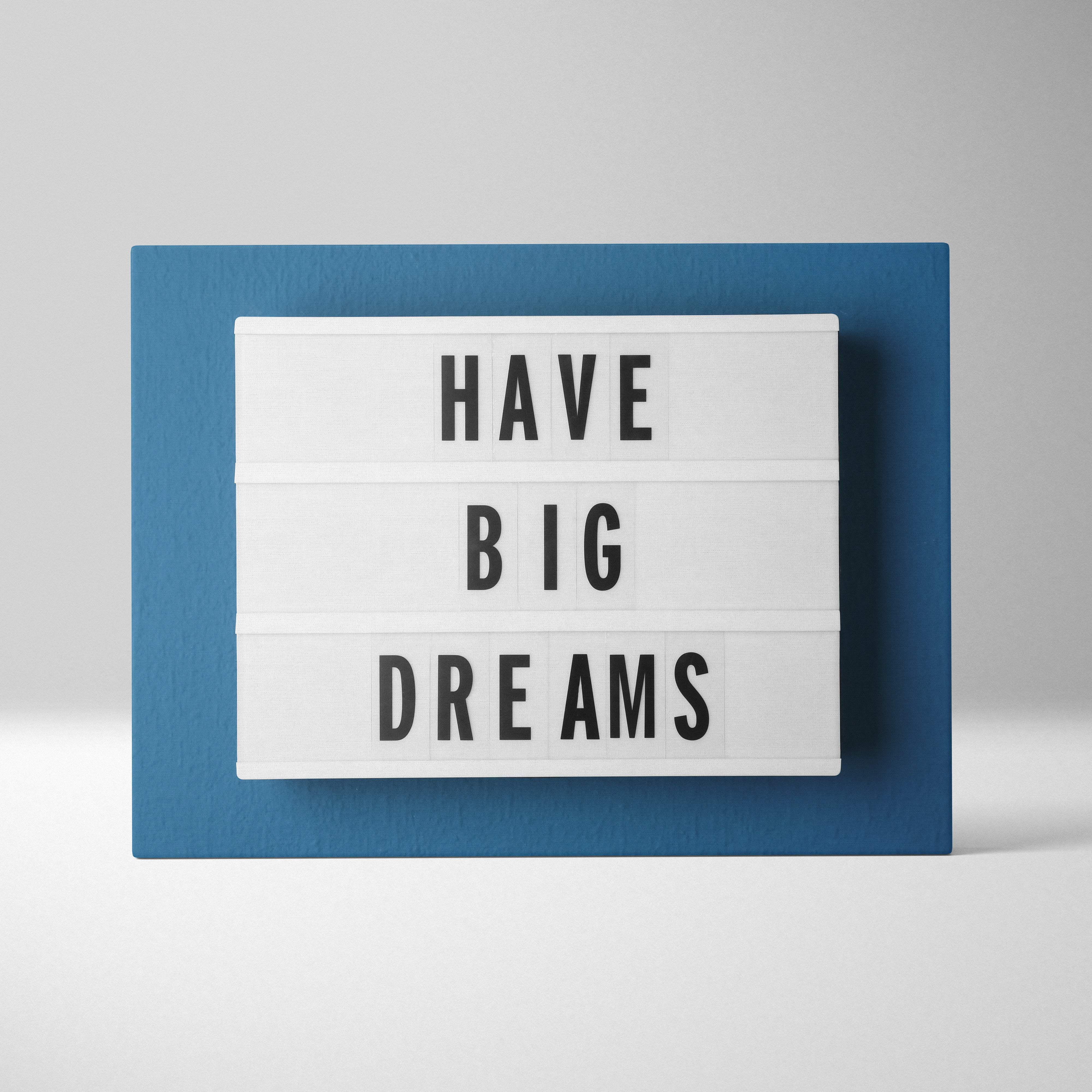 Blue-framed lightbox displaying have big dreams message in black on white panels minimalist motivational wall art print