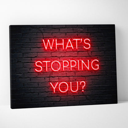Red neon sign reading whats stopping you mounted on black brick wall motivational wall art print for office gym or bedroom