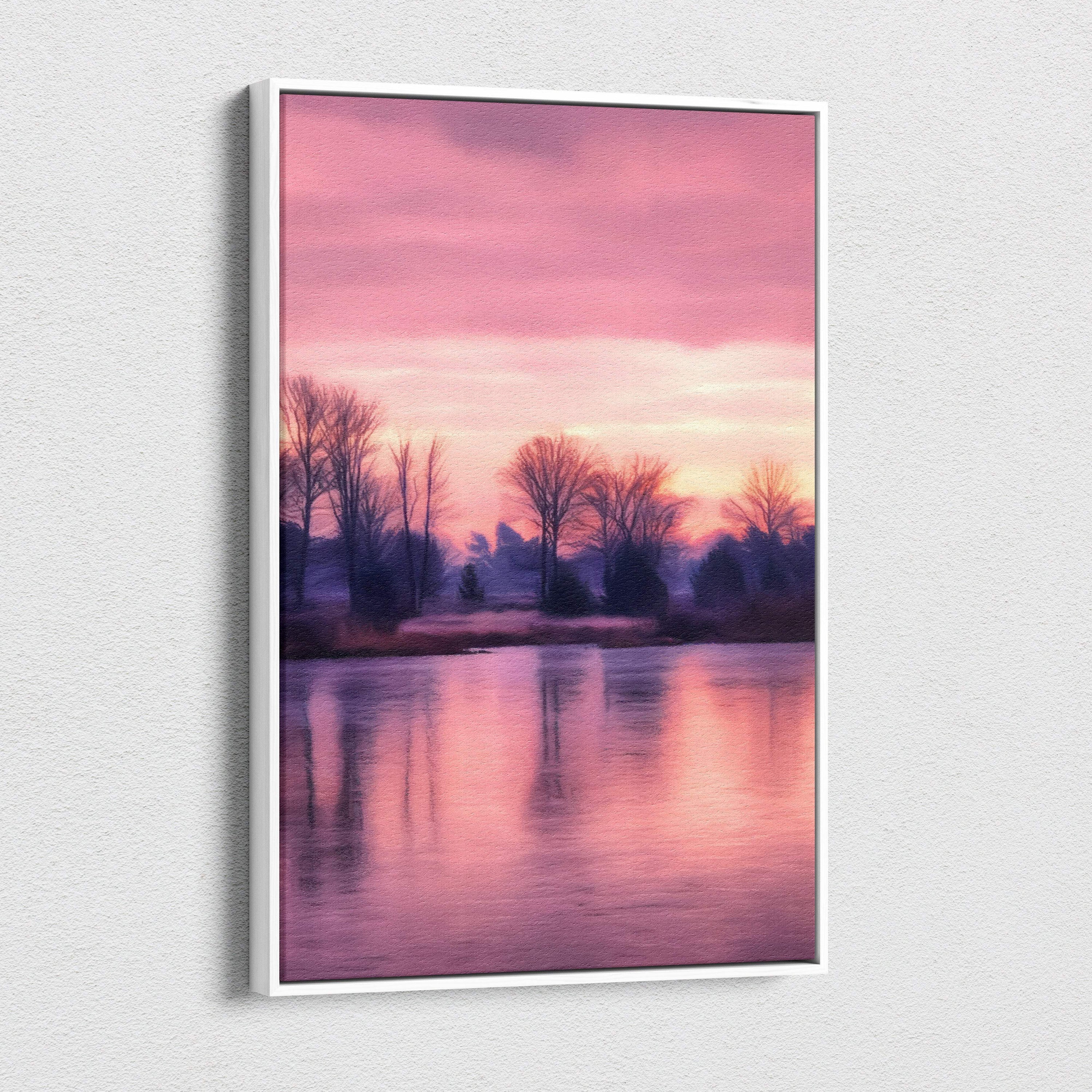 A framed canvas print of a serene pink sunset lake with tree silhouettes and calm water reflections in soft pastels